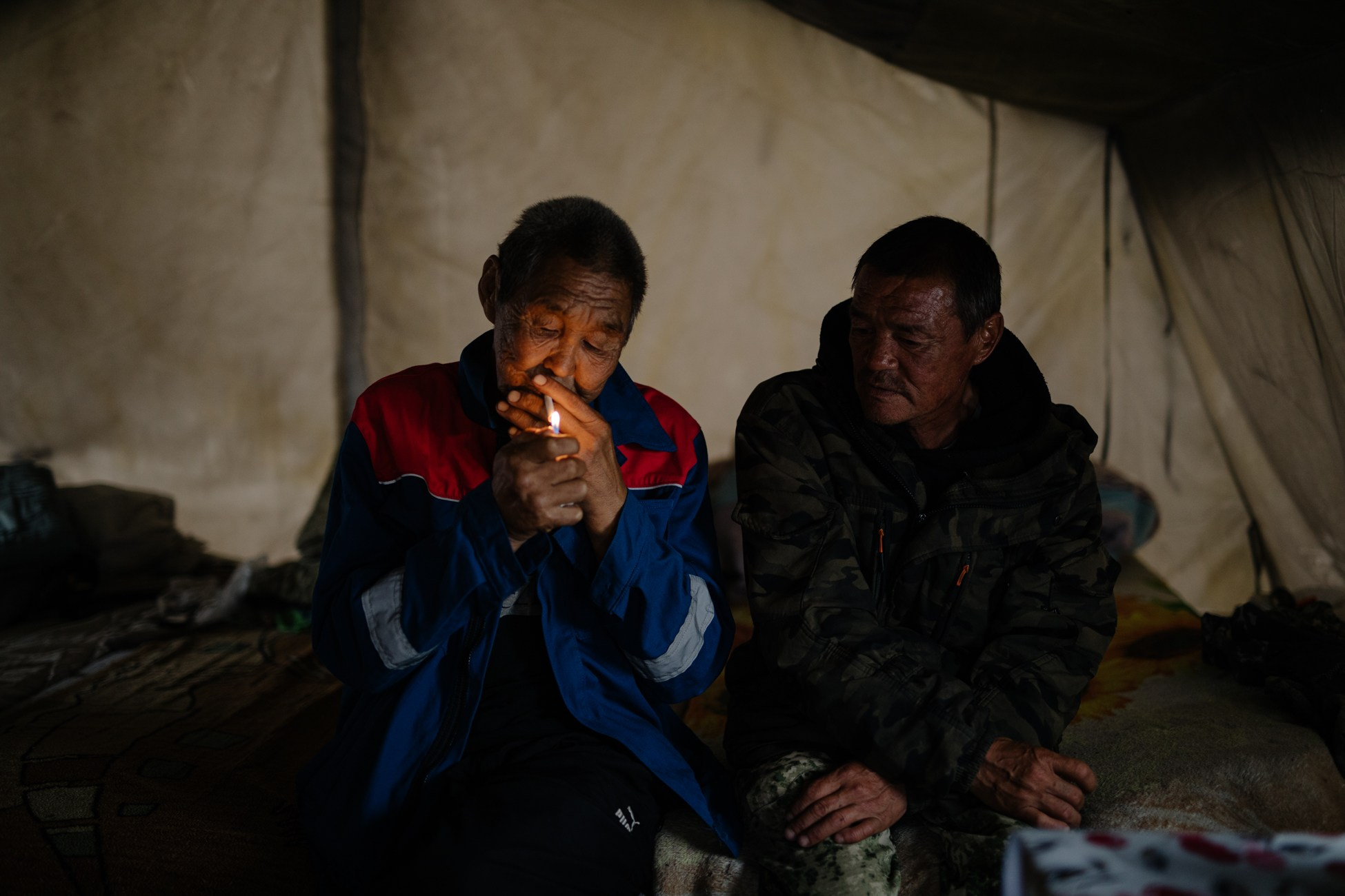 Reindeer herding brothers Oleg (Uilta) and Sergey Stepanov (Uilta) are resting in a tent.