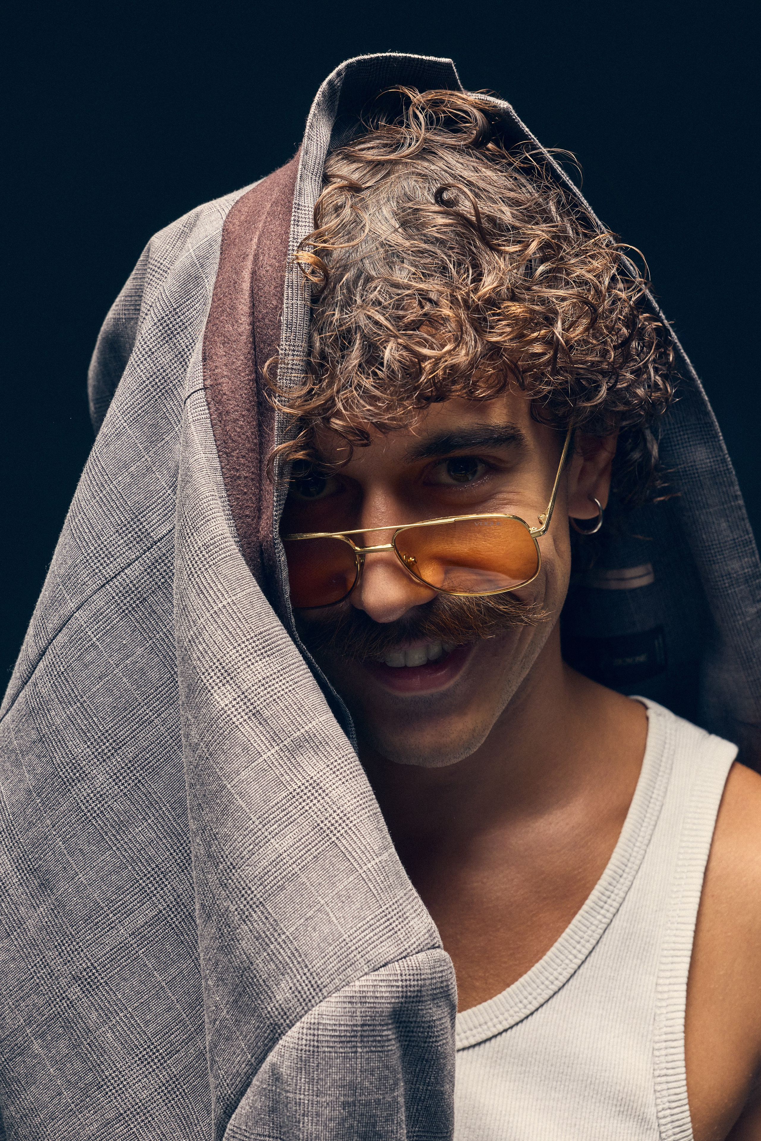 Studio shot of male model with flour bag and bottle of tequila beside him