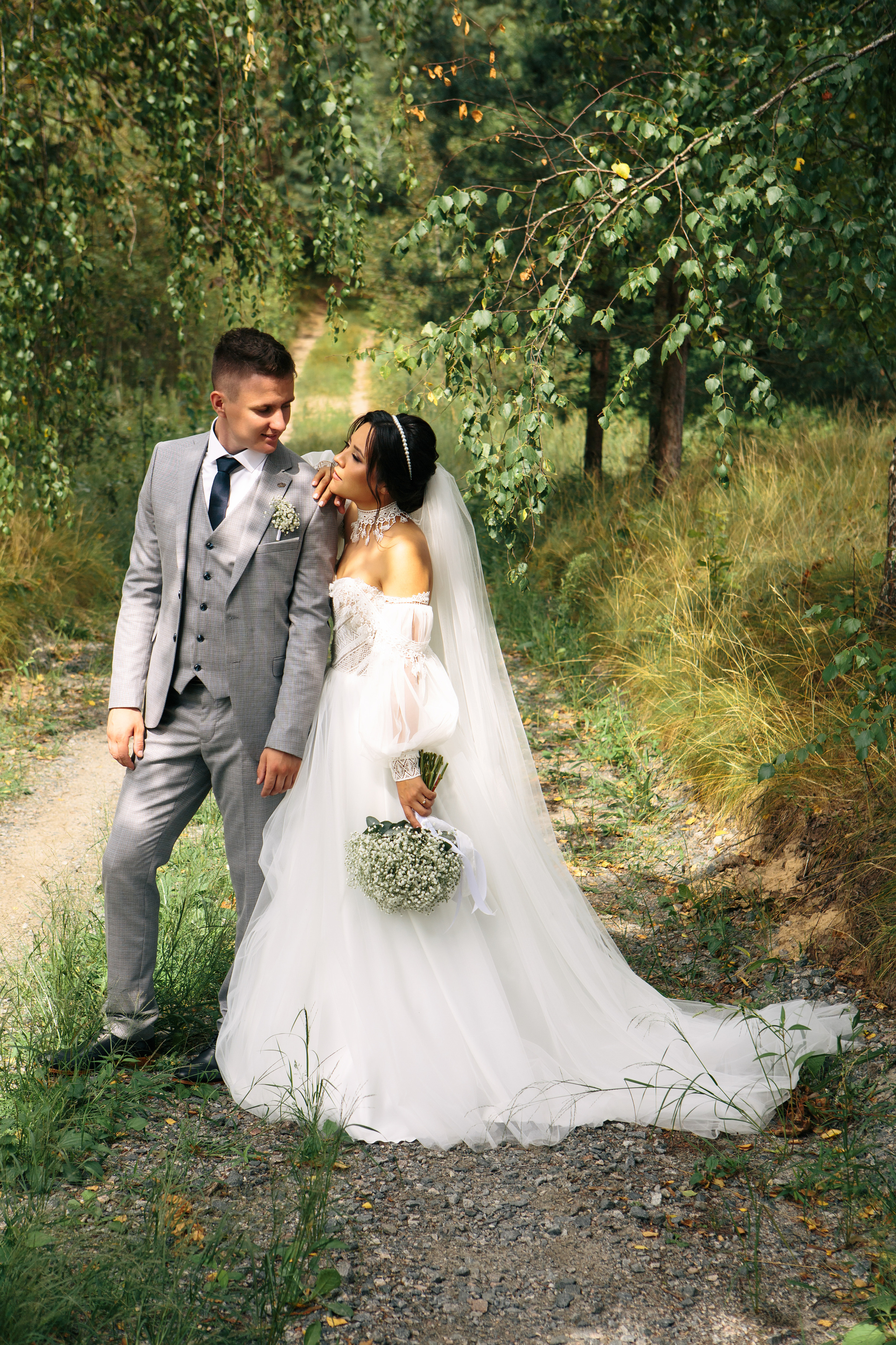 Жених с невестой в красивом платье в лесу