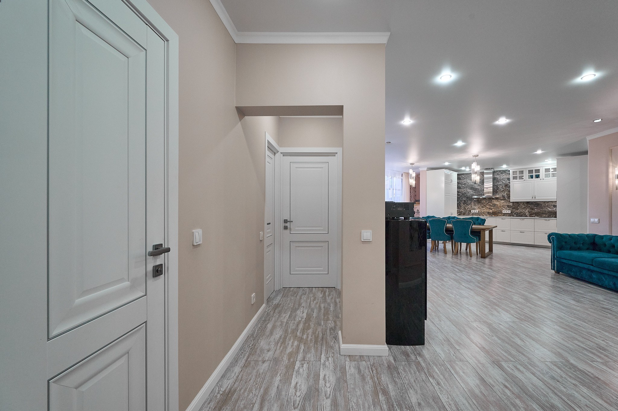 коридор с нежно розовыми обоями белыми деревянными дверями 