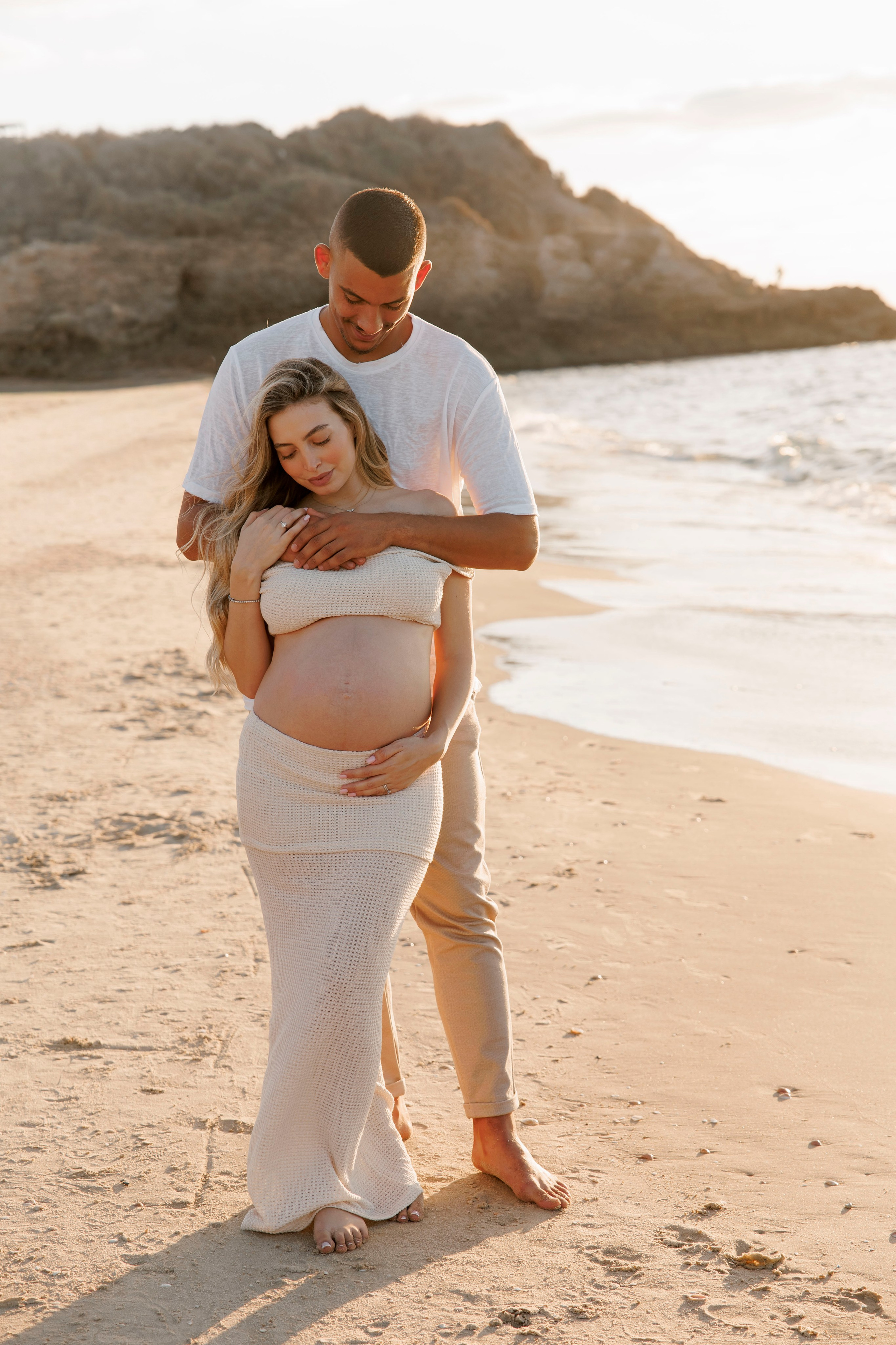 Pregnancy photoshoot near the sea. Wedding and family photographer