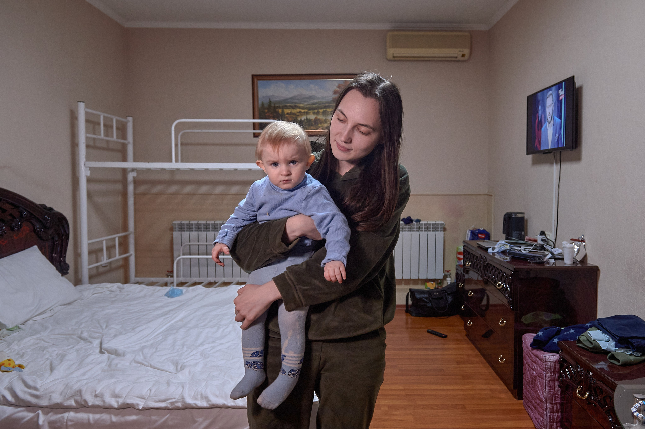 Larisa Minasyan from Stakhanov, Luhansk region, evacuated on February 20, 2022, holds her child in a temporary refugee accommodation center set up in the Aelita Hotel in Rostov-on-Don, February 22, 2022.