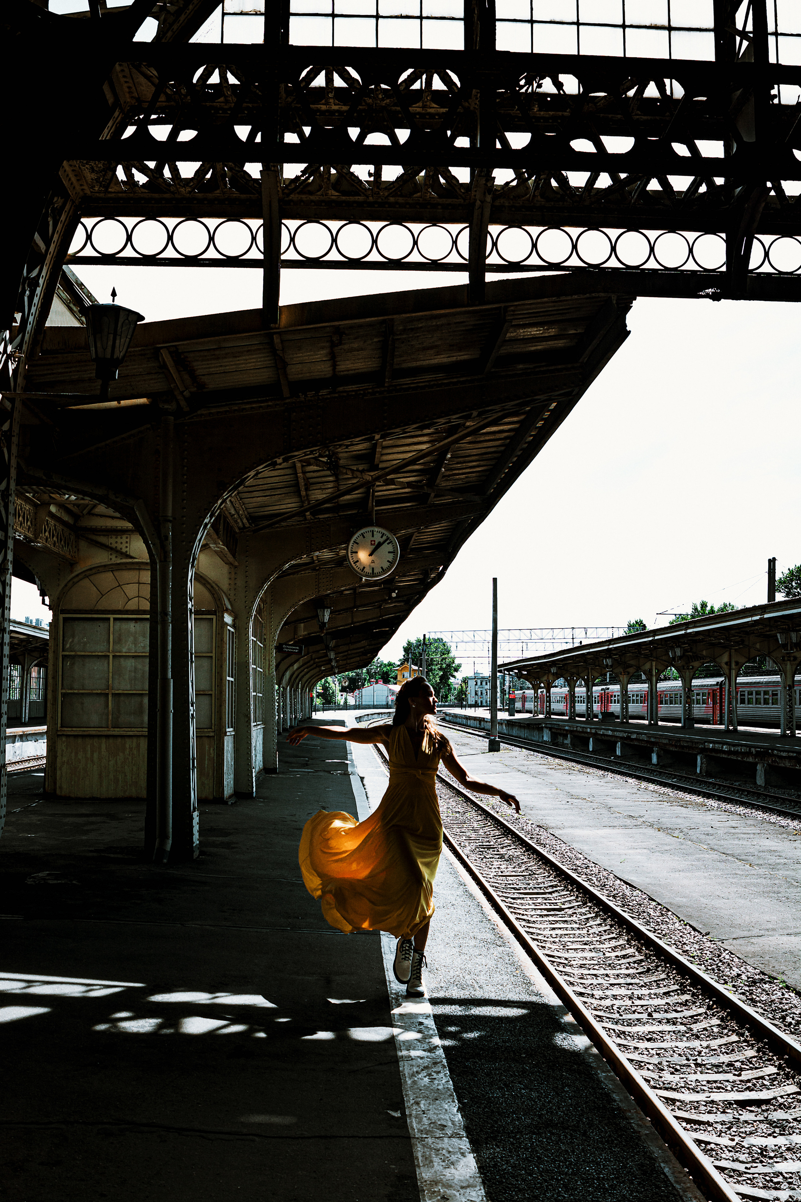 Яркая и стильная девушка, танцующая в желтом платье на Витебском вокзале.