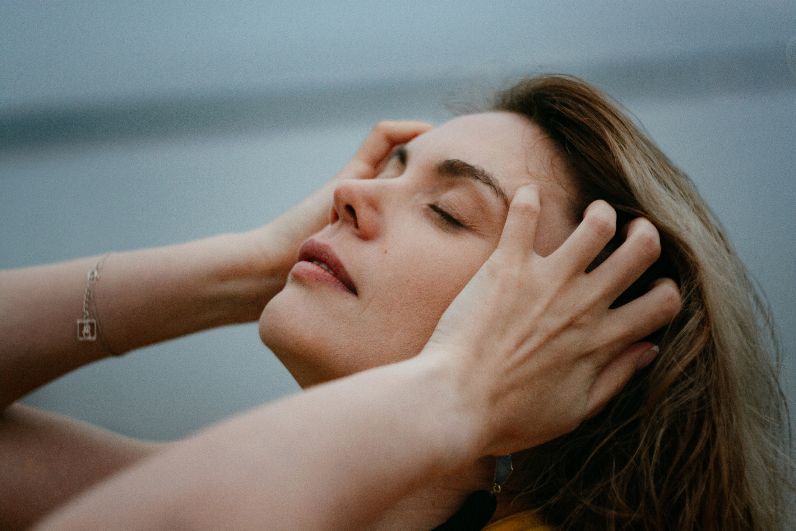 Волнующий портрет девушки в ярком желтом платье, передающий атмосферу спокойствия и восхищения невероятной красотой заката на Финском заливе.