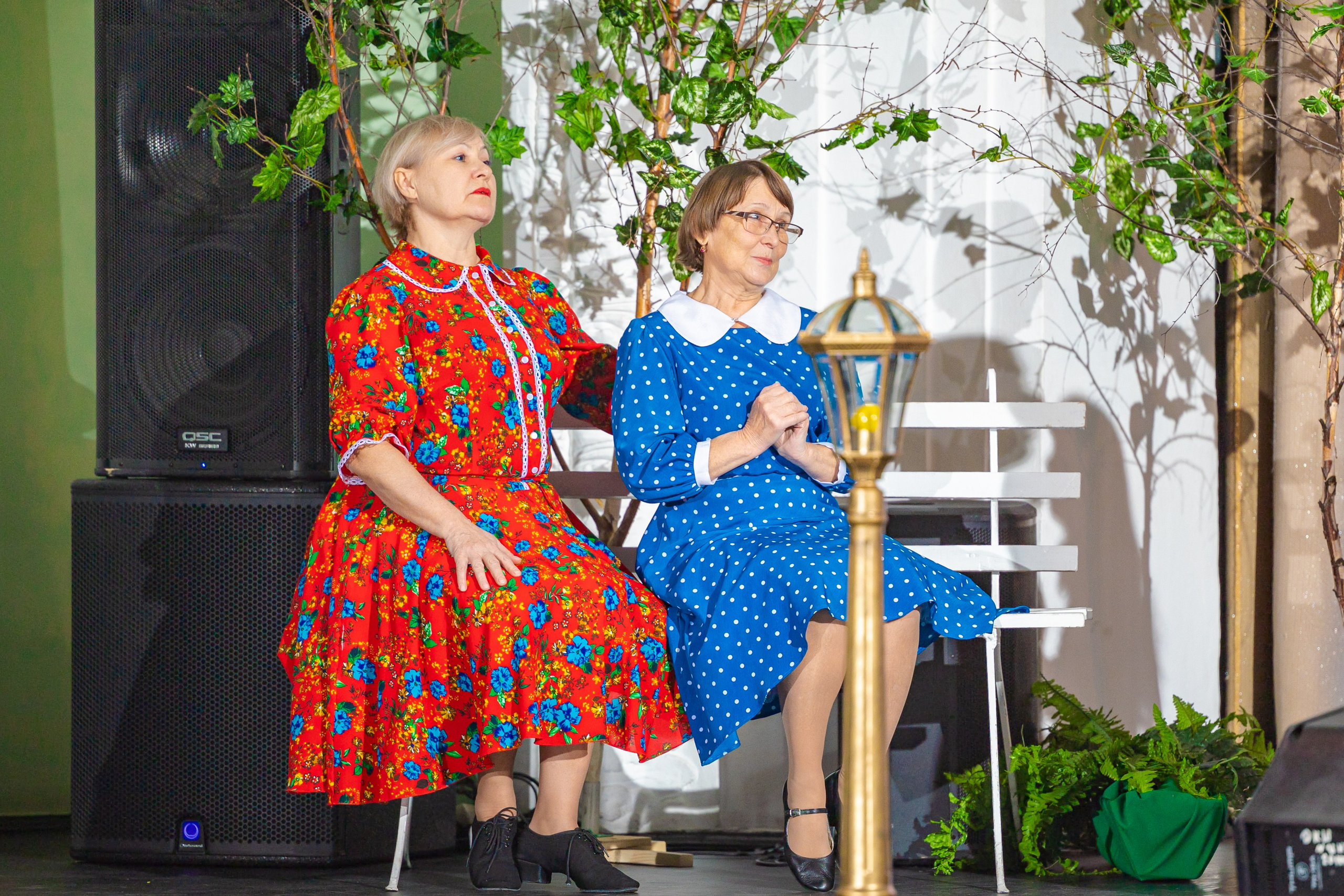 Актриса пожилого возраста сидят на сцене на скамейке дома культуры шахтёров Кемерово