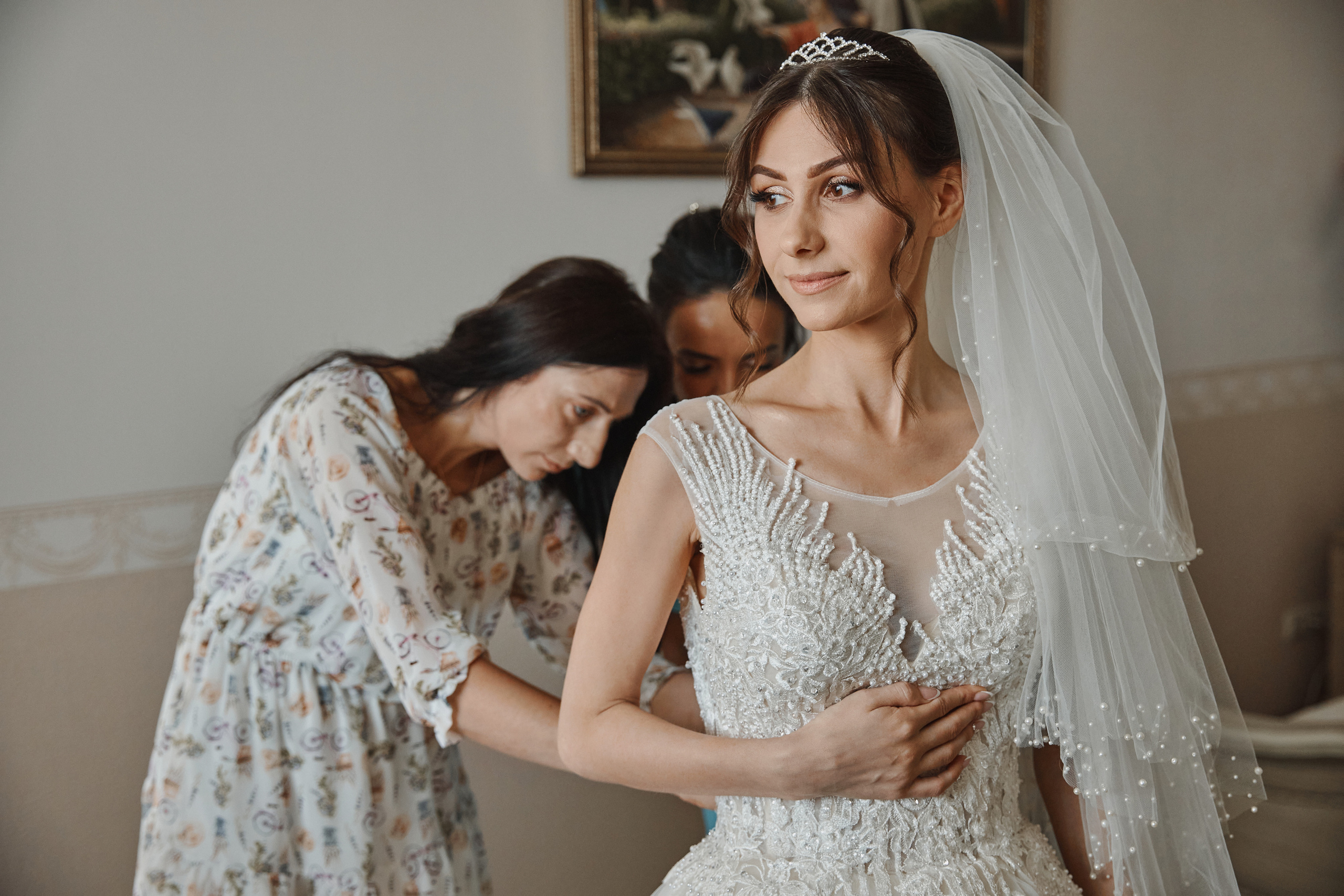 Подружки невесты помогают надевать платье