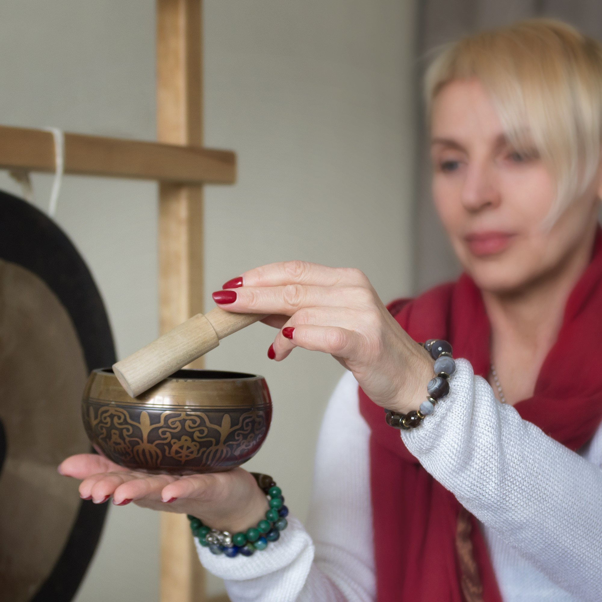 Поющая чаша в руках у инструктора йоги. Телесные практики, очищение, душевное здоровье.