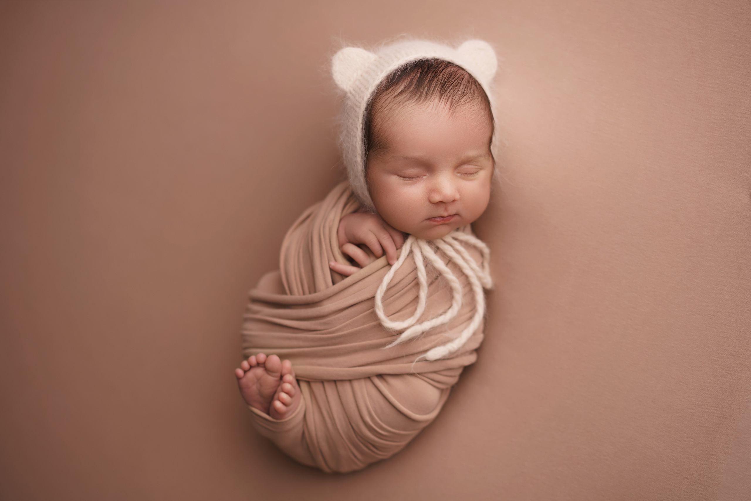 Мальчик в коконе с шапочкой мишки - трогательная newborn-фотосессия