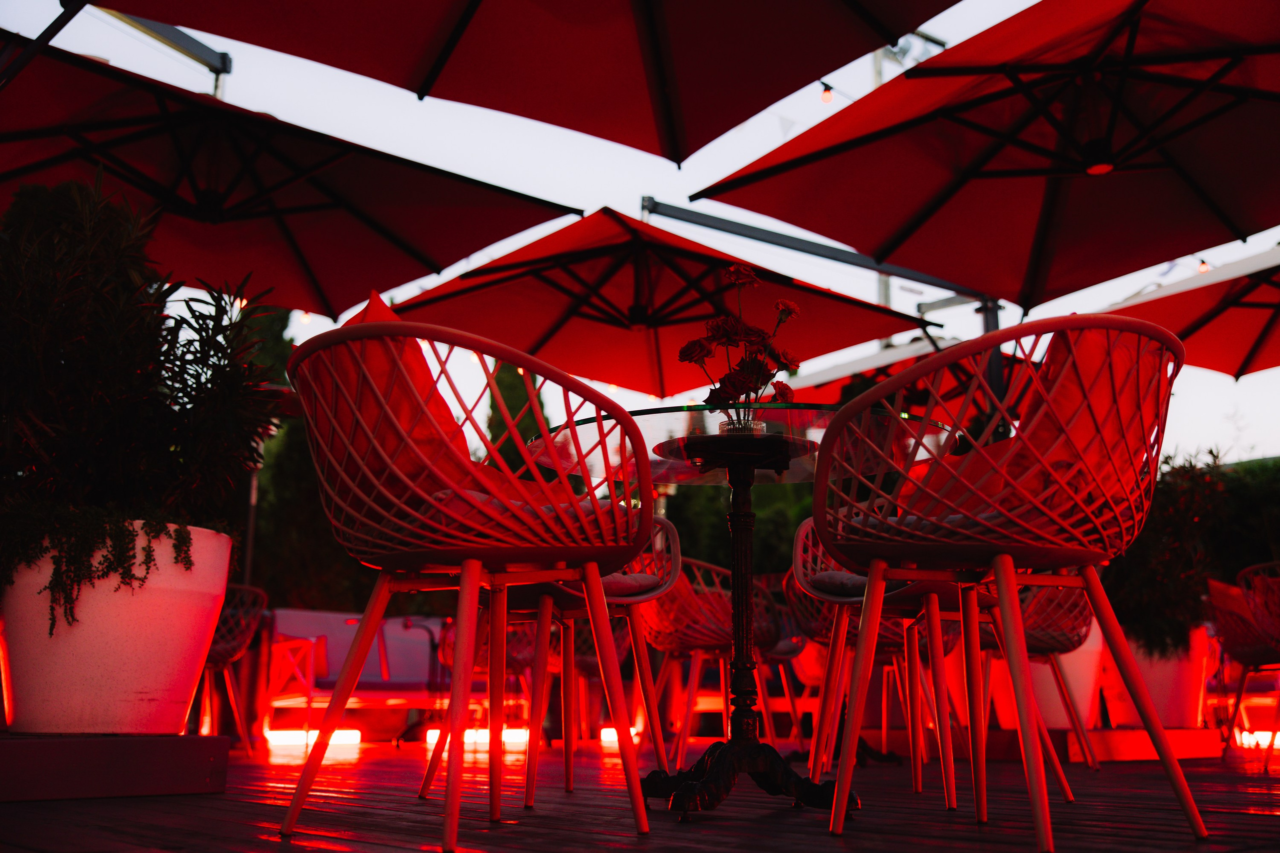 Интерьер: Стильная зона отдыха с высокими красными стульями и современным освещением.