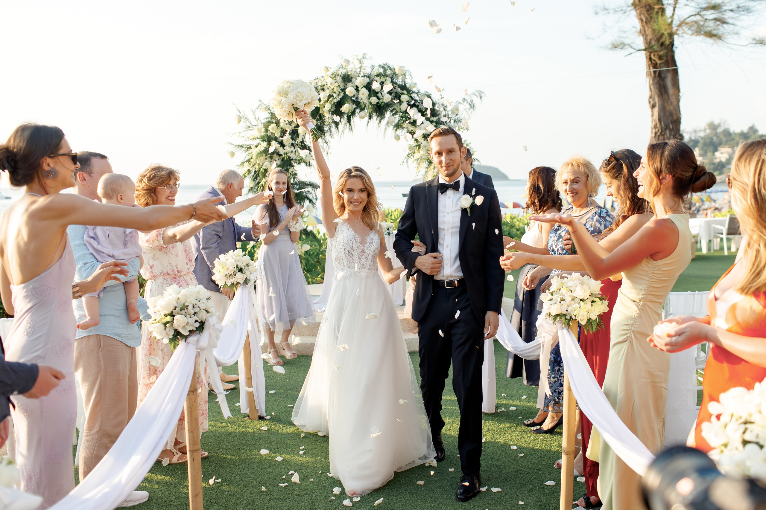 гости бросают лепестки на молодоженов