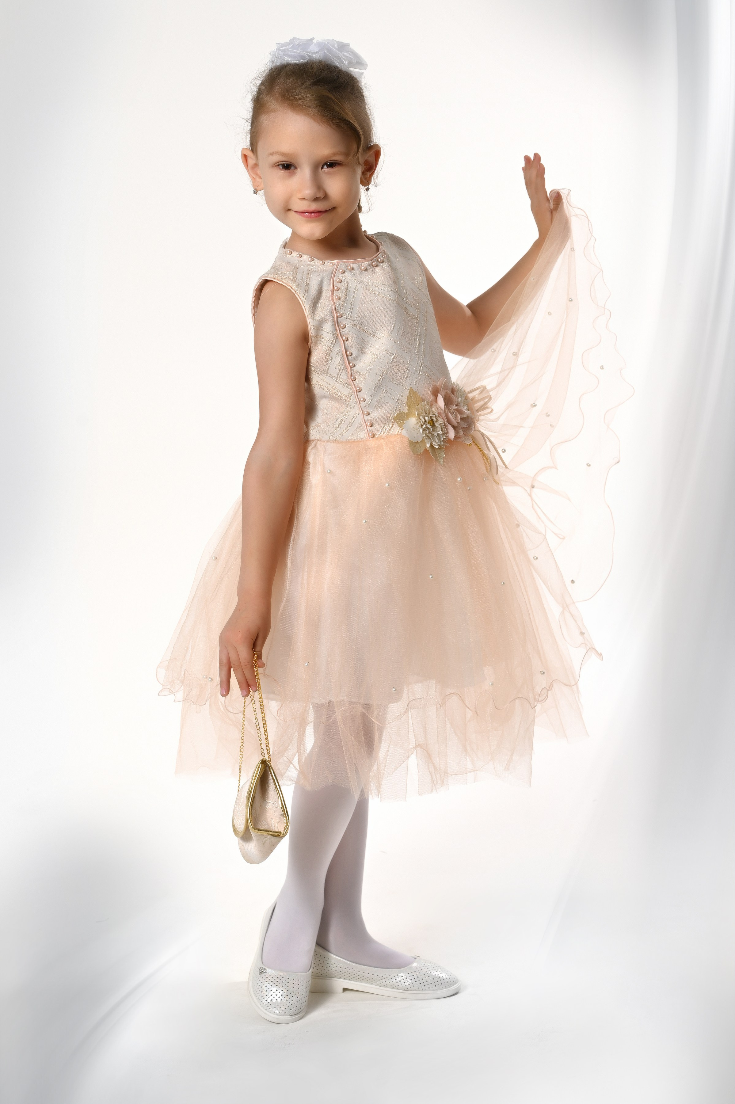 Девочка в бежевом выпускном платье в фотостудии