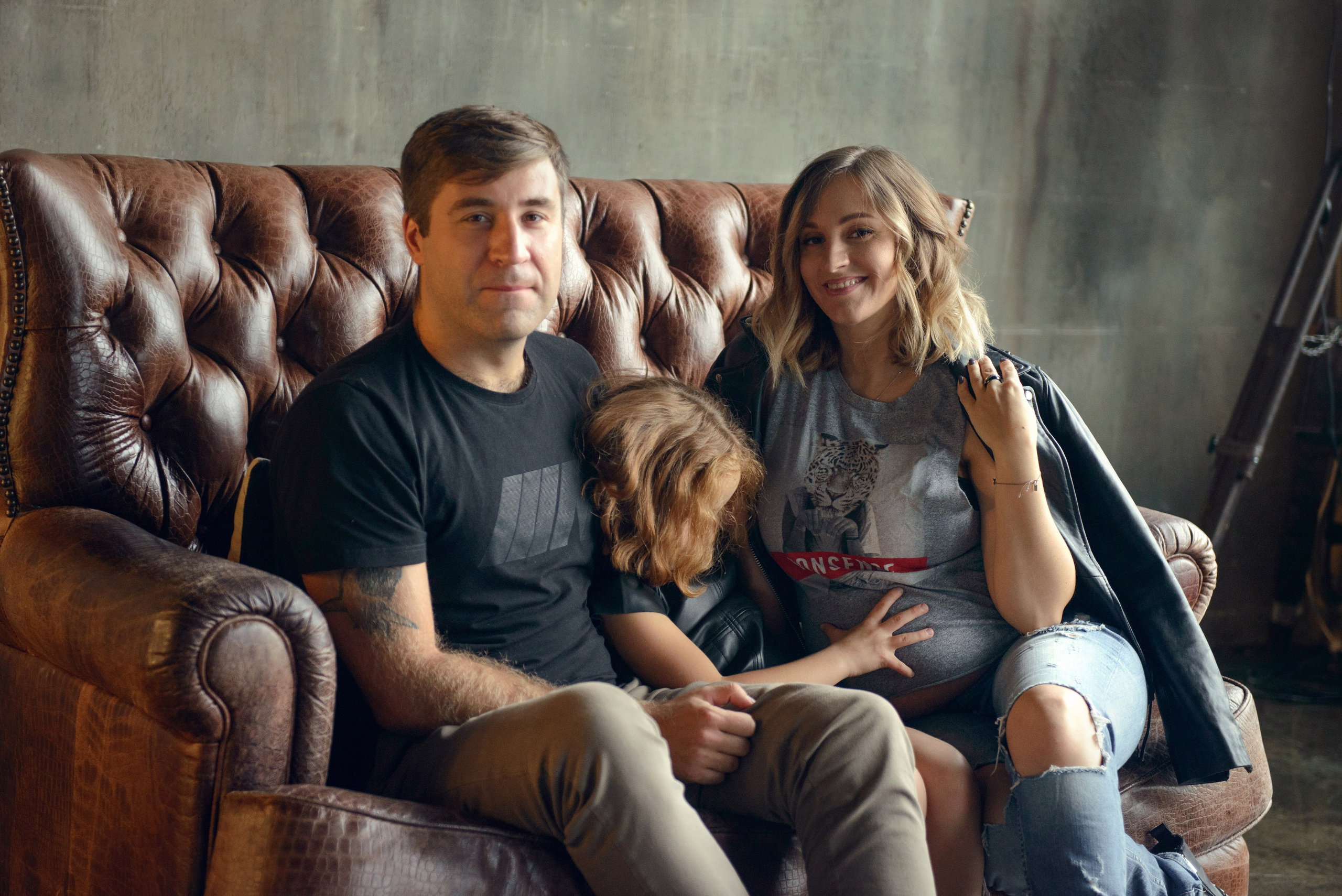 dad and daughter in a dark photo studio