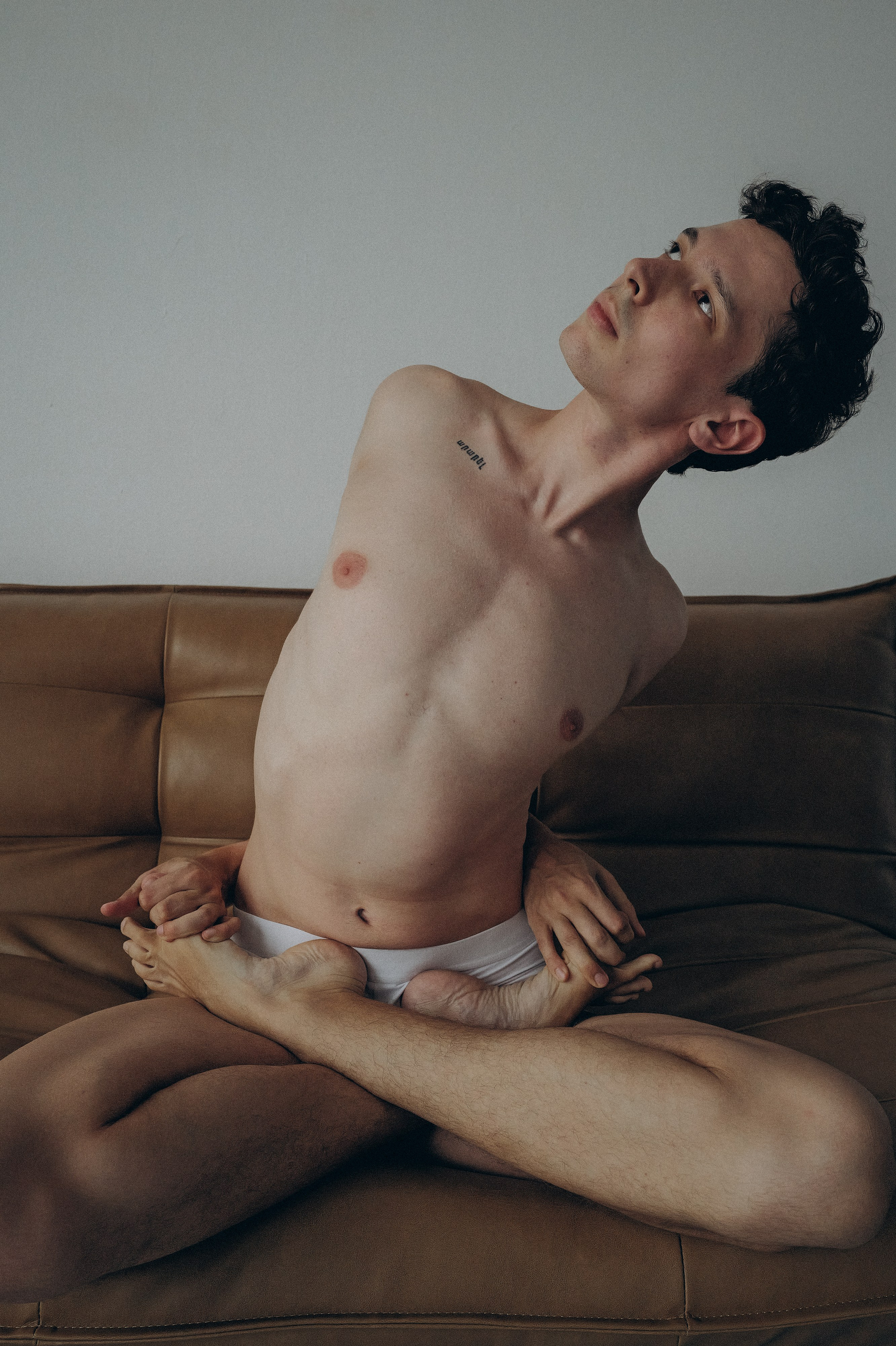 Contemporary Barcelona portrait of a man laughing behind curtain folds