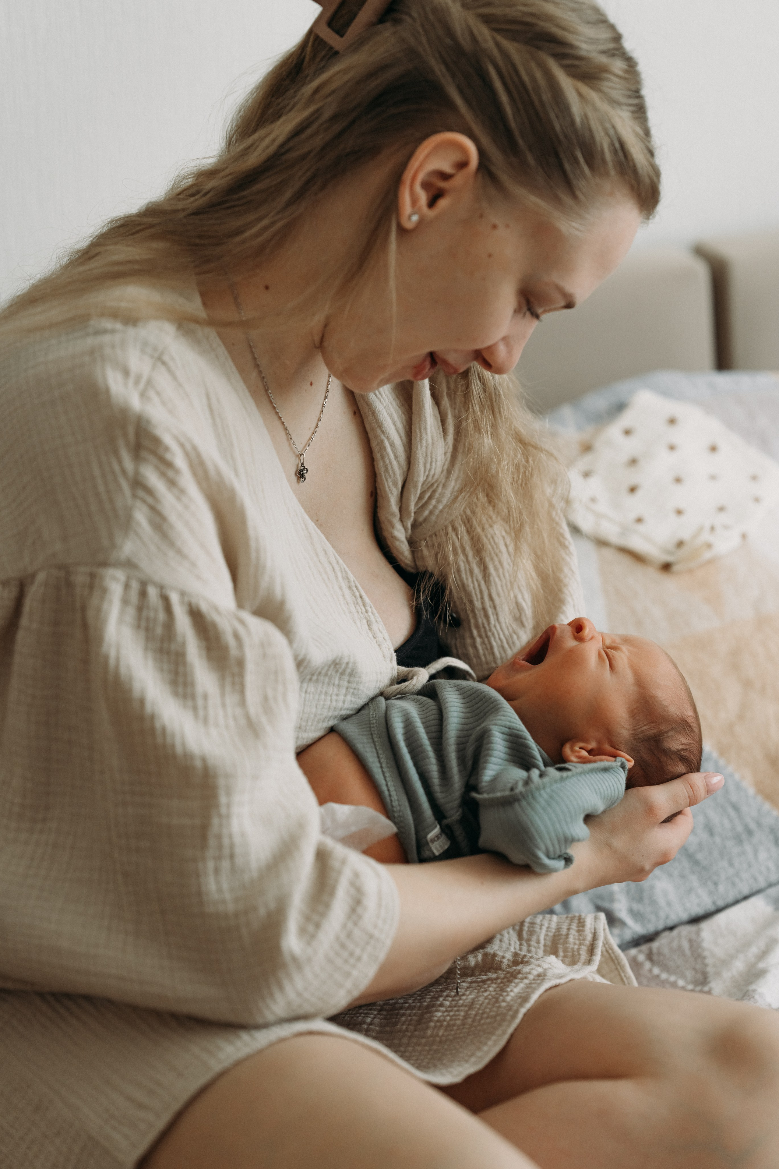 Домашняя фотосессия новорожденного - мама обнимает ножка малыша