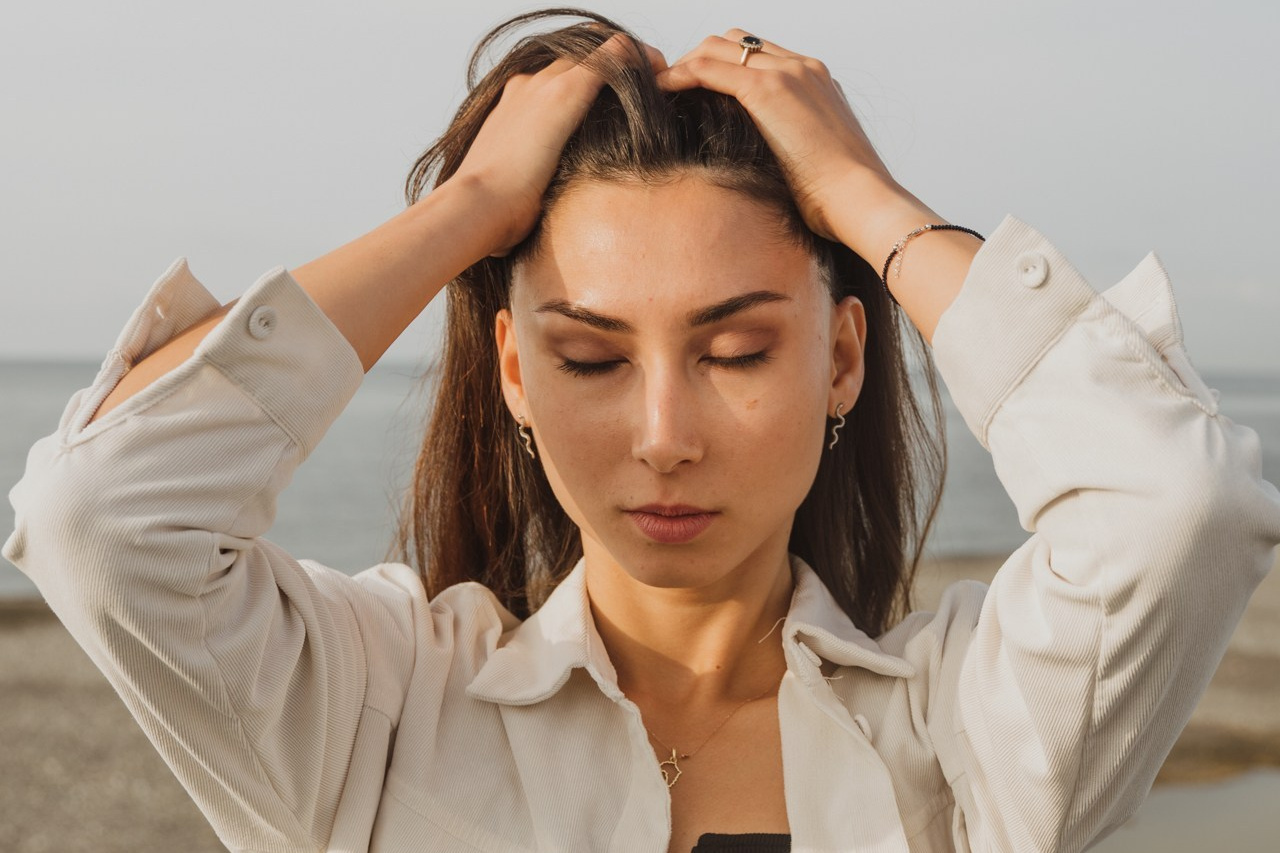 Изображение девушка которая держит руками волосы на рассвете