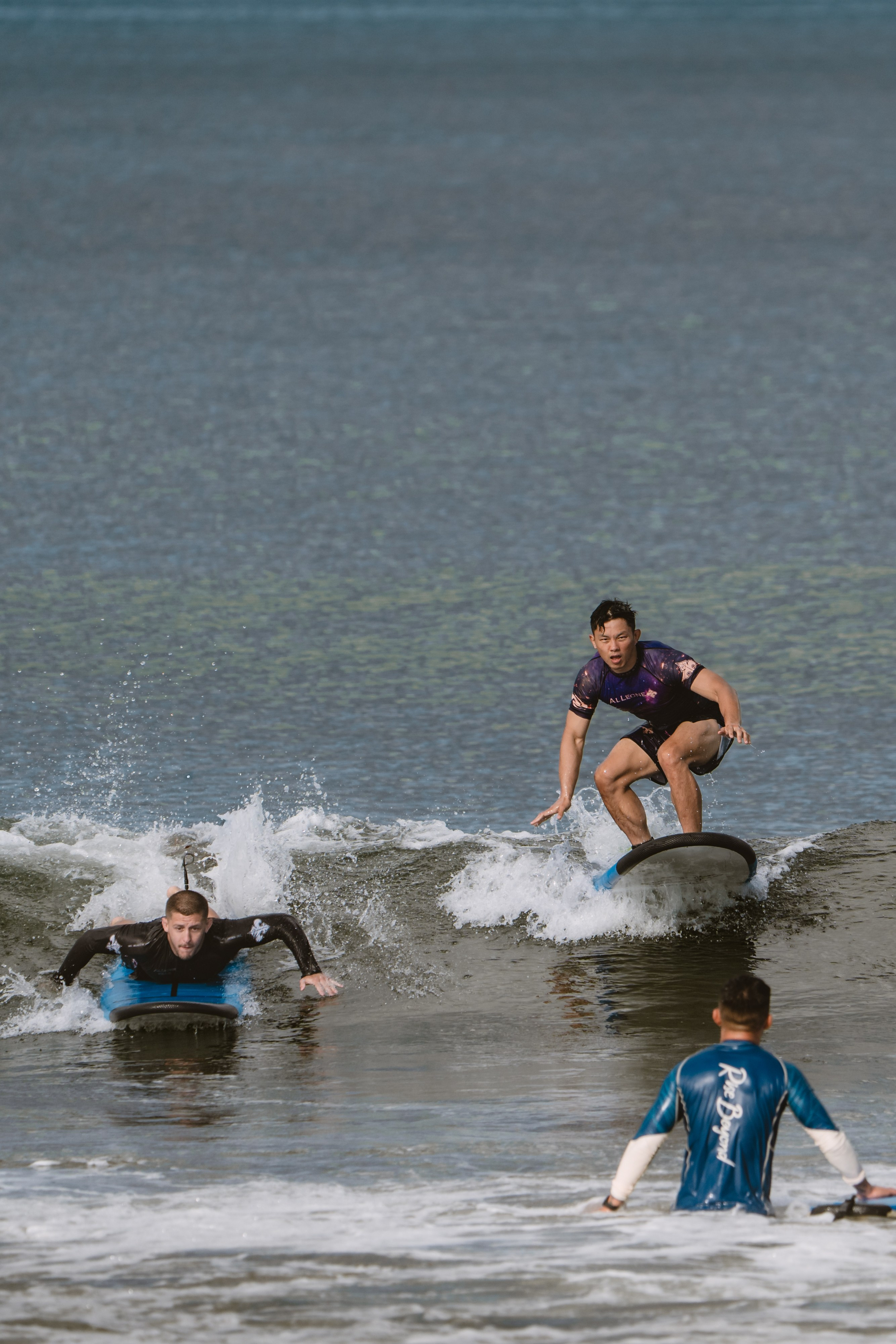 Mixed martial artists having fun surfing at the ocean in between training sessions. Сергей Зворыгин