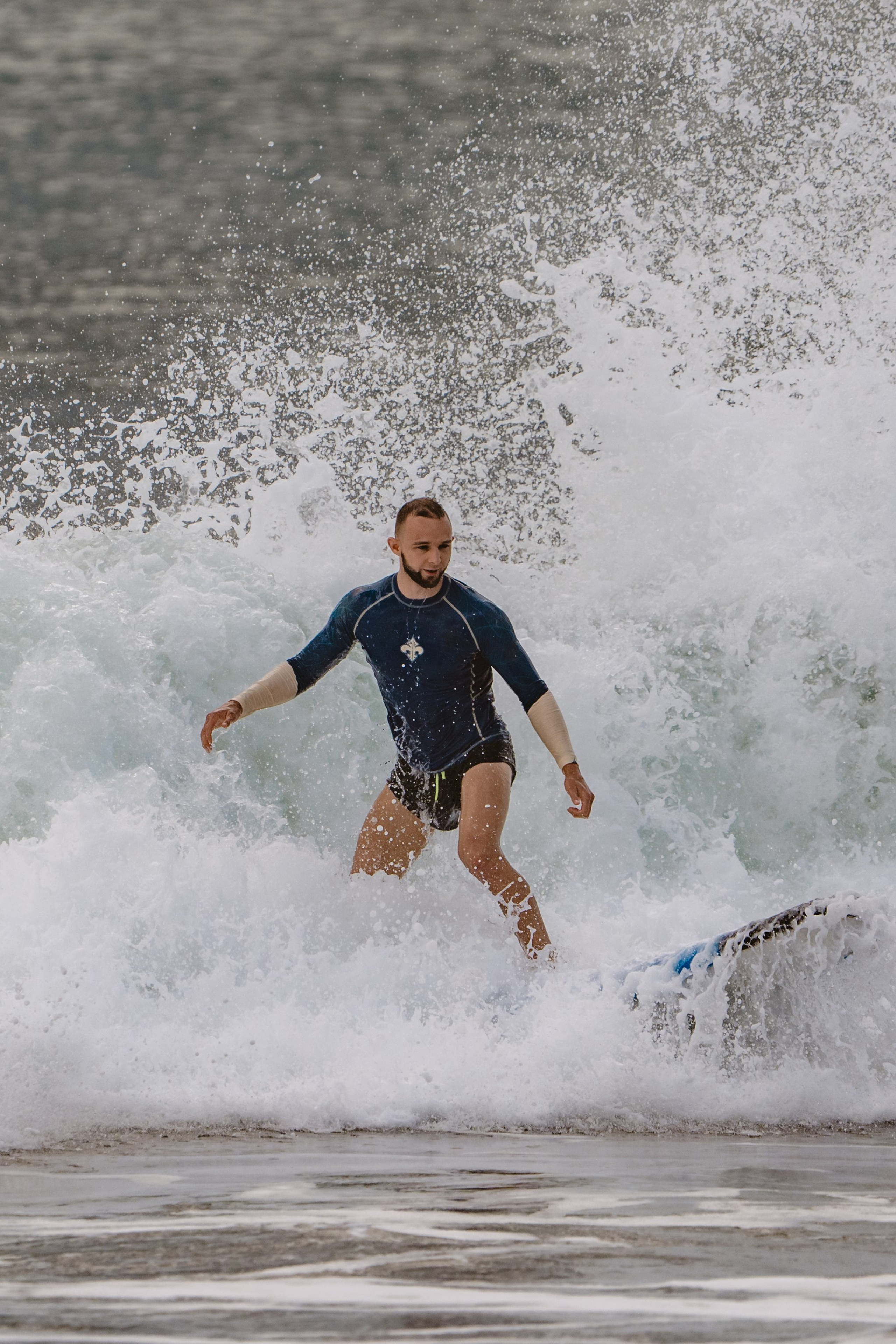 Mixed martial artists having fun surfing at the ocean in between training sessions. Сергей Зворыгин