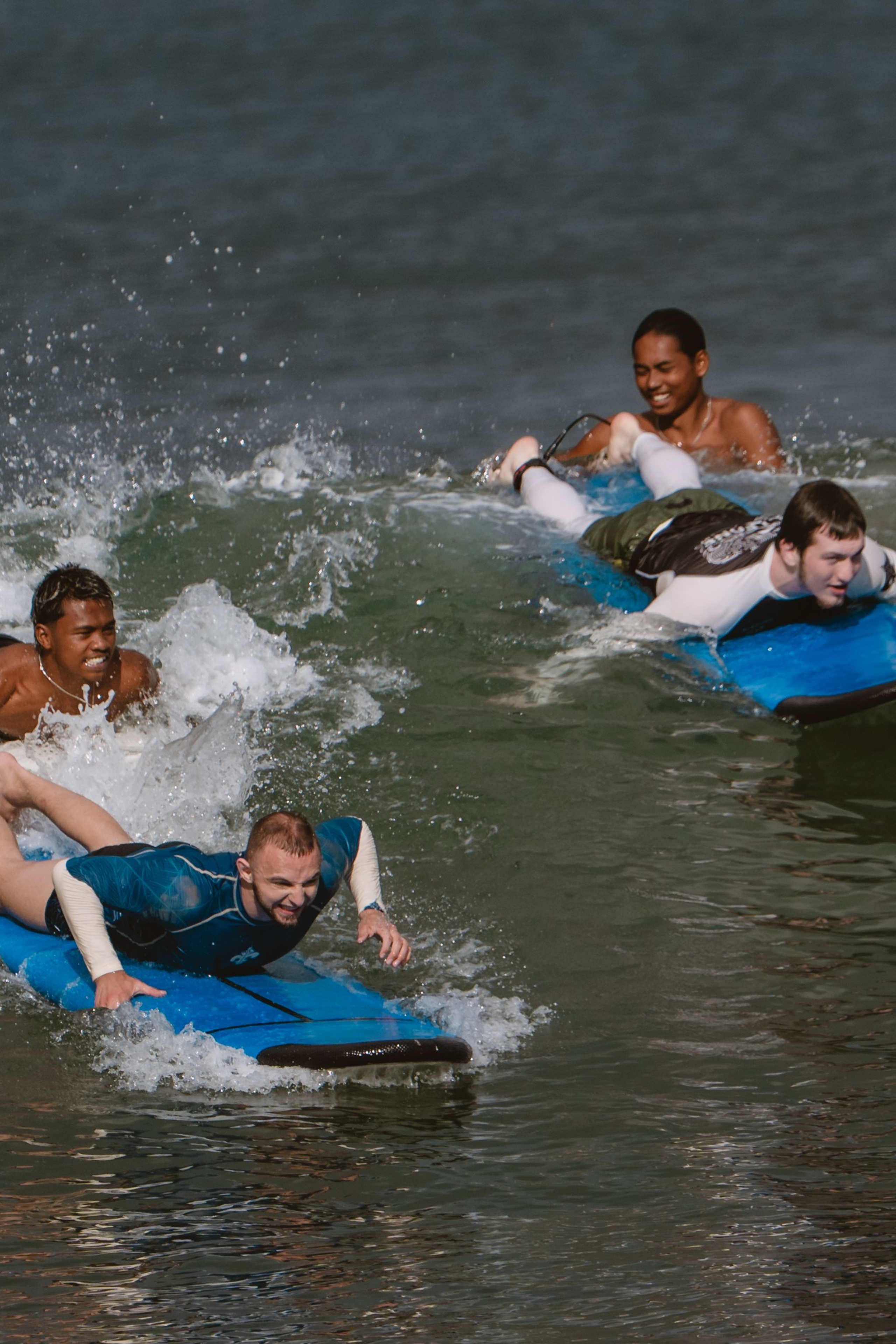 Mixed martial artists having fun surfing at the ocean in between training sessions. Сергей Зворыгин