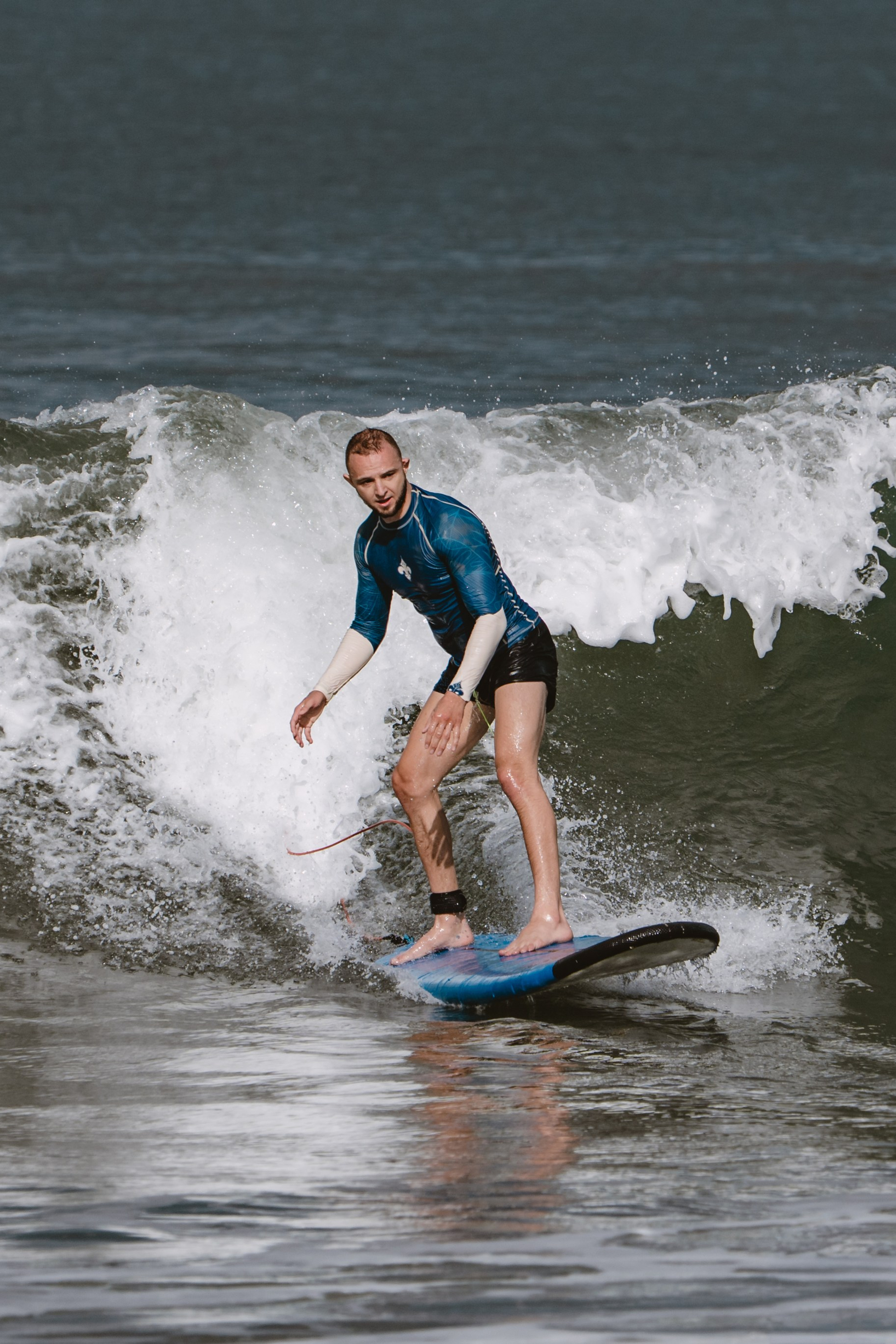 Mixed martial artists having fun surfing at the ocean in between training sessions. Сергей Зворыгин
