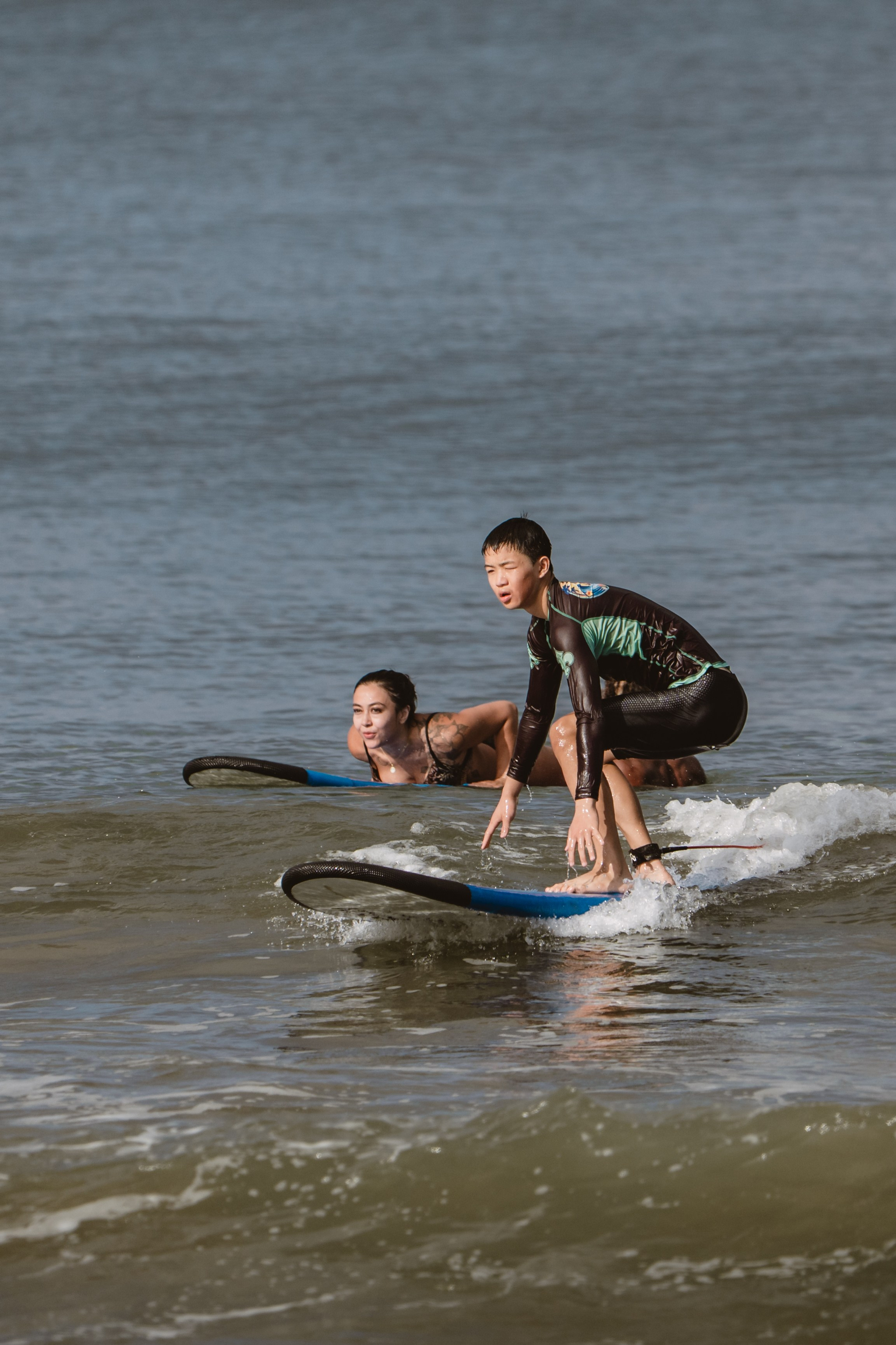 Mixed martial artists having fun surfing at the ocean in between training sessions. Сергей Зворыгин