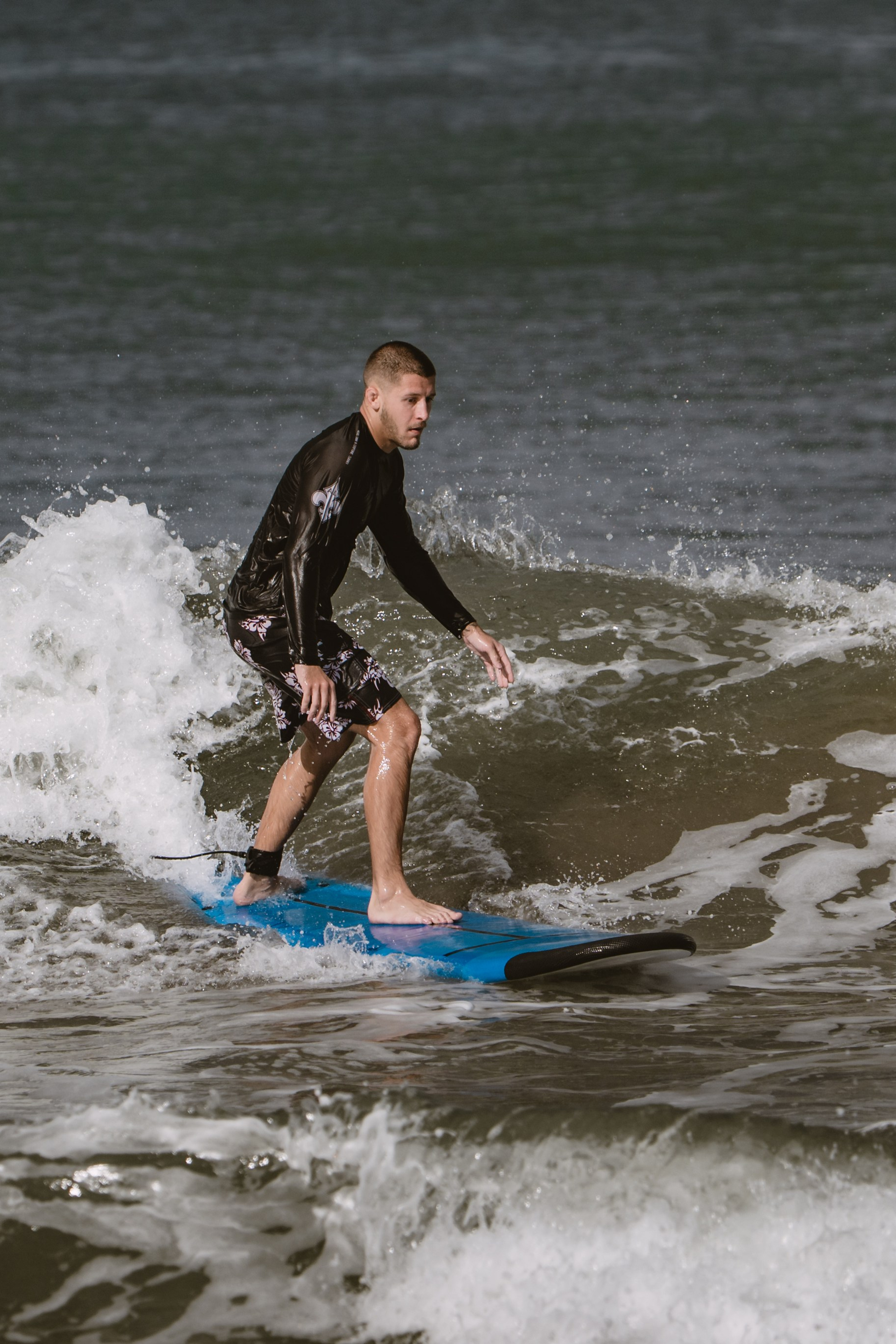 Mixed martial artists having fun surfing at the ocean in between training sessions. Сергей Зворыгин