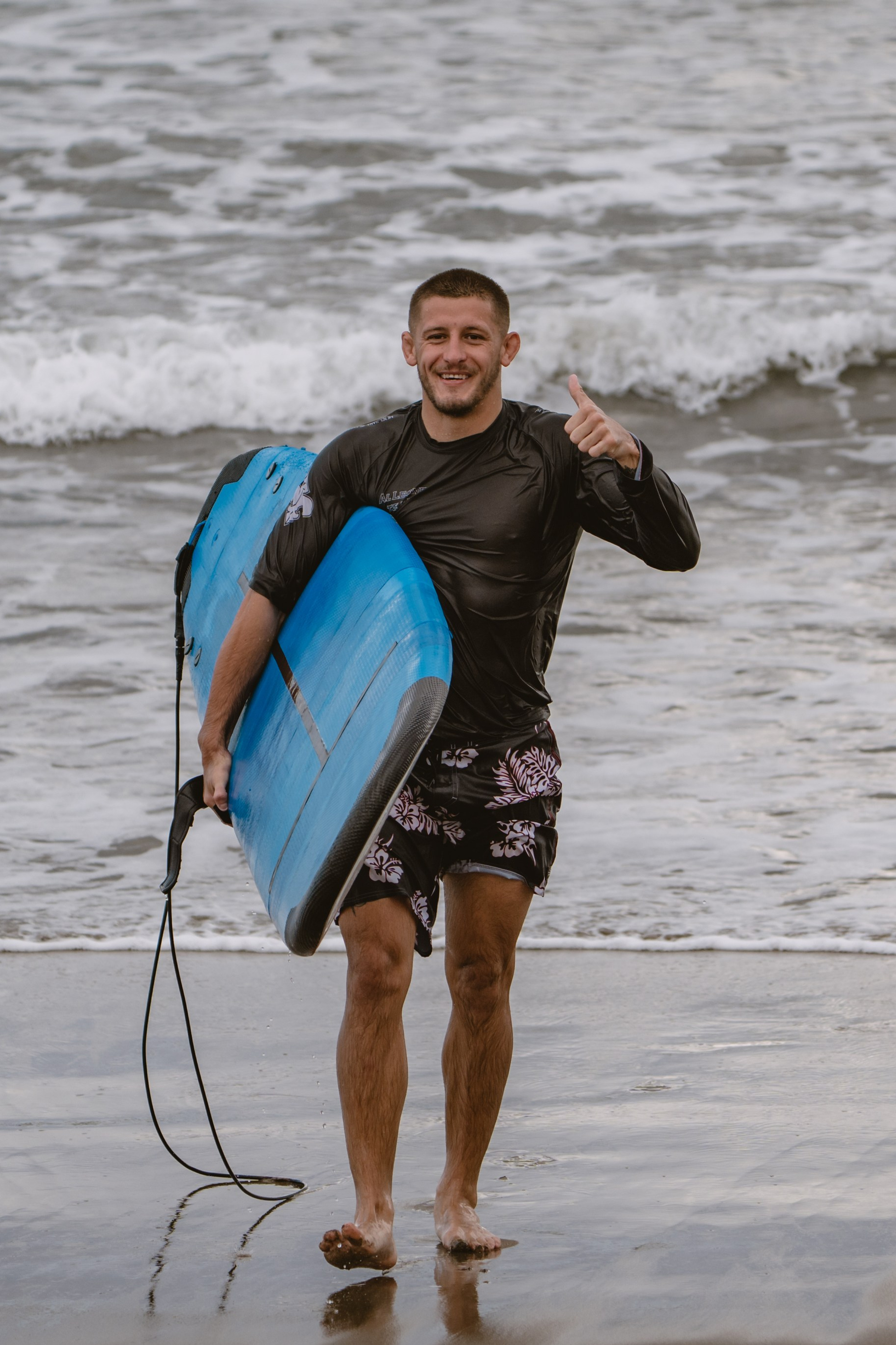 Mixed martial artists having fun surfing at the ocean in between training sessions. Сергей Зворыгин