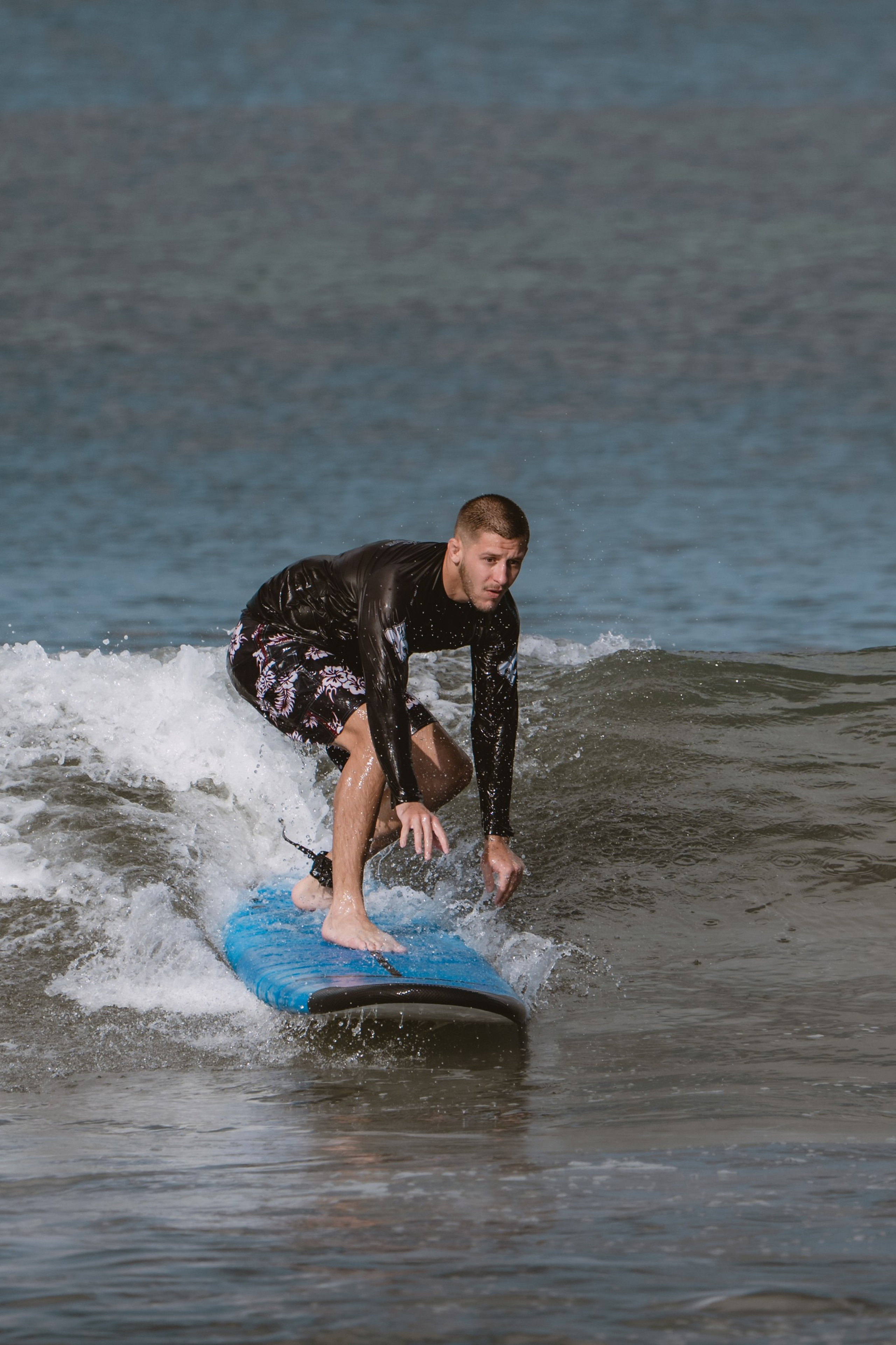 Mixed martial artists having fun surfing at the ocean in between training sessions. Сергей Зворыгин
