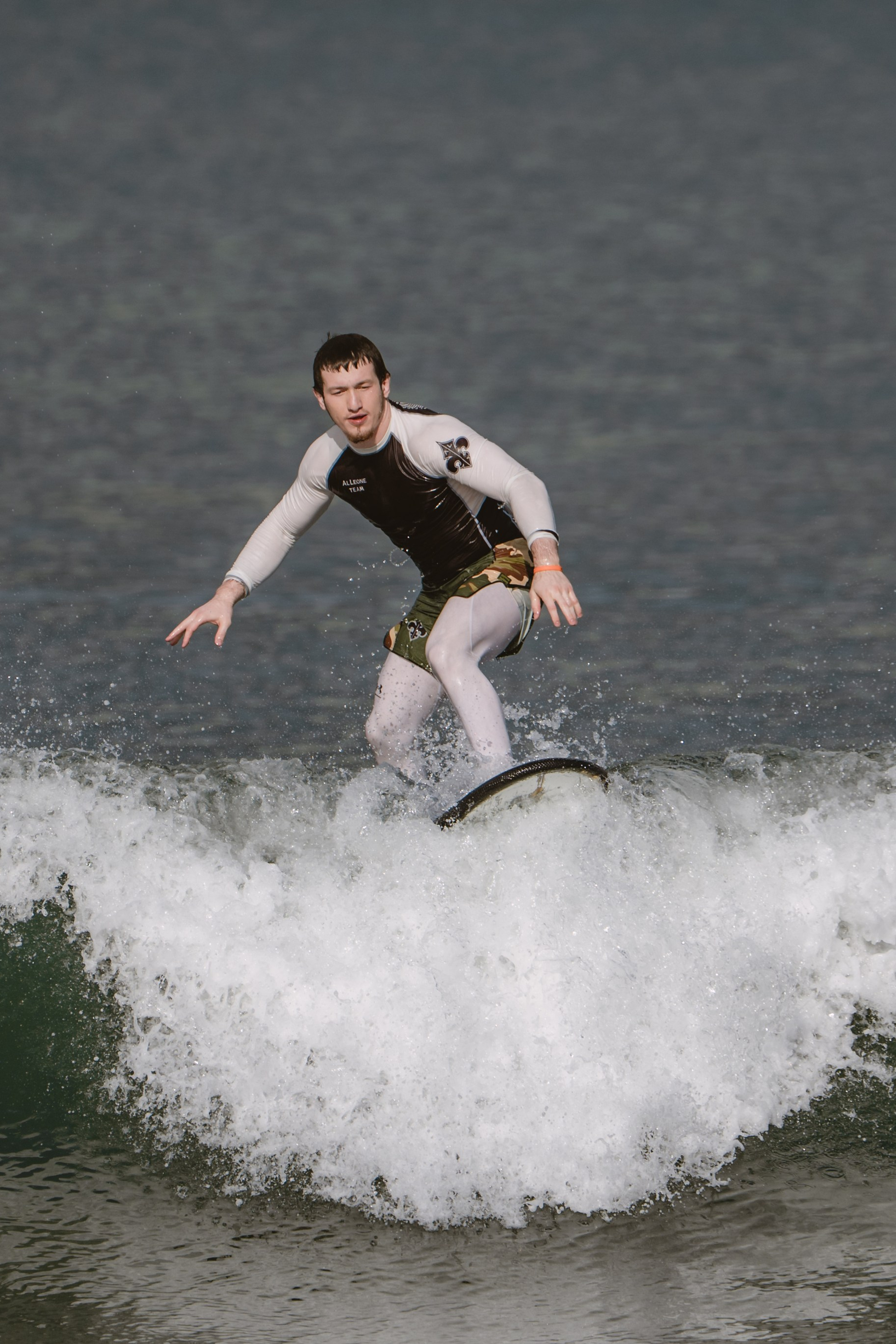 Mixed martial artists having fun surfing at the ocean in between training sessions. Сергей Зворыгин