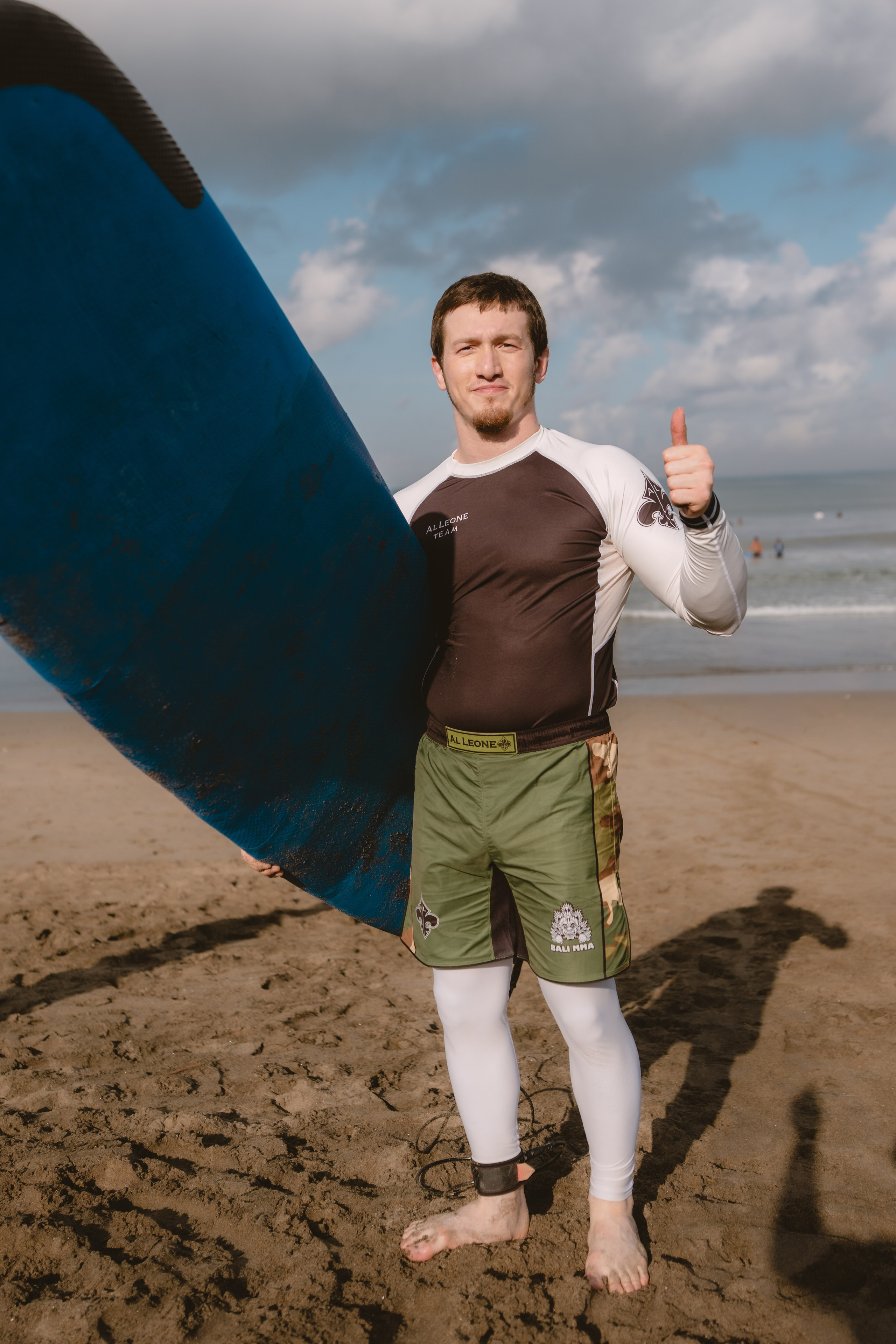 Mixed martial artists having fun surfing at the ocean in between training sessions. Сергей Зворыгин