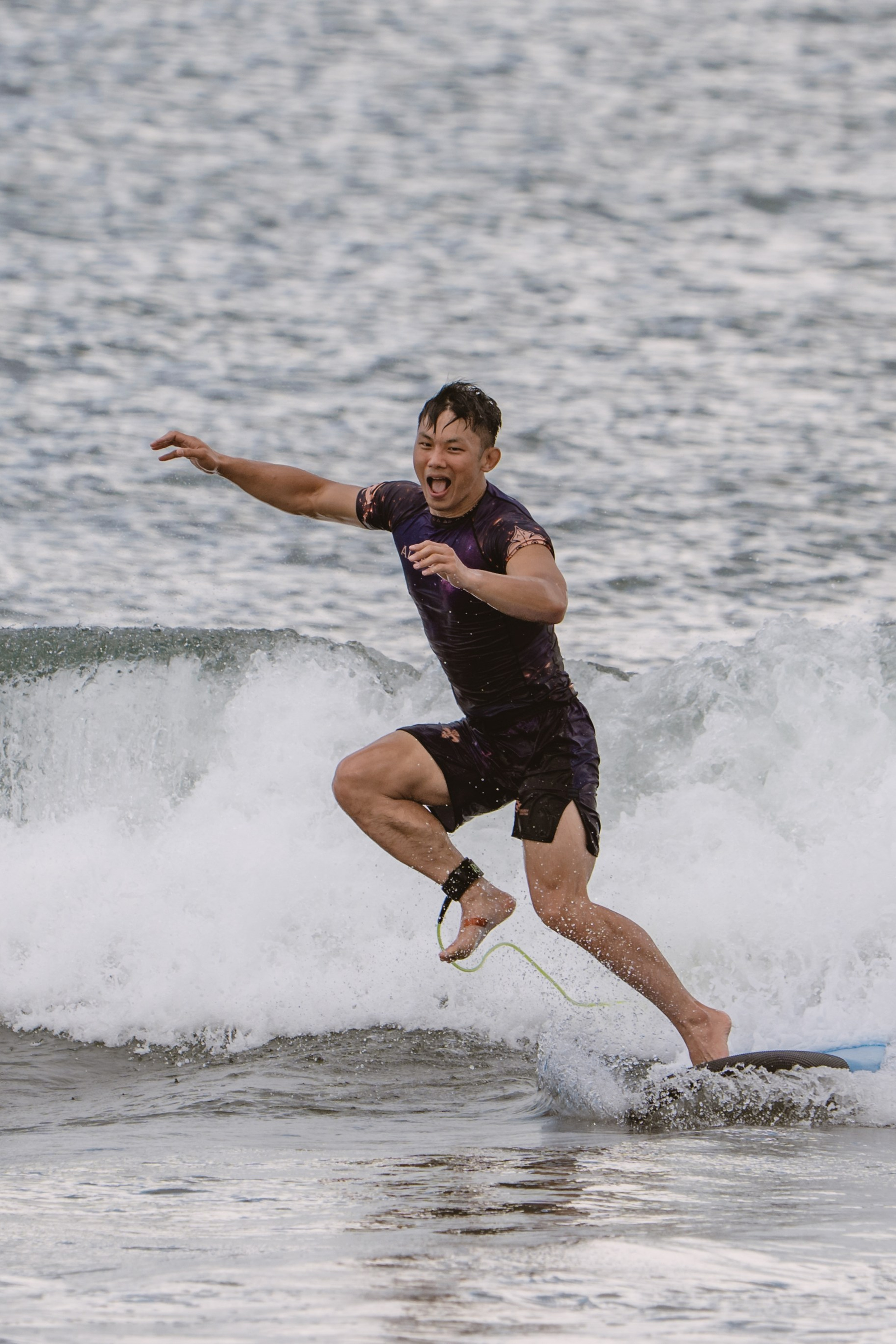 Mixed martial artists having fun surfing at the ocean in between training sessions. Сергей Зворыгин