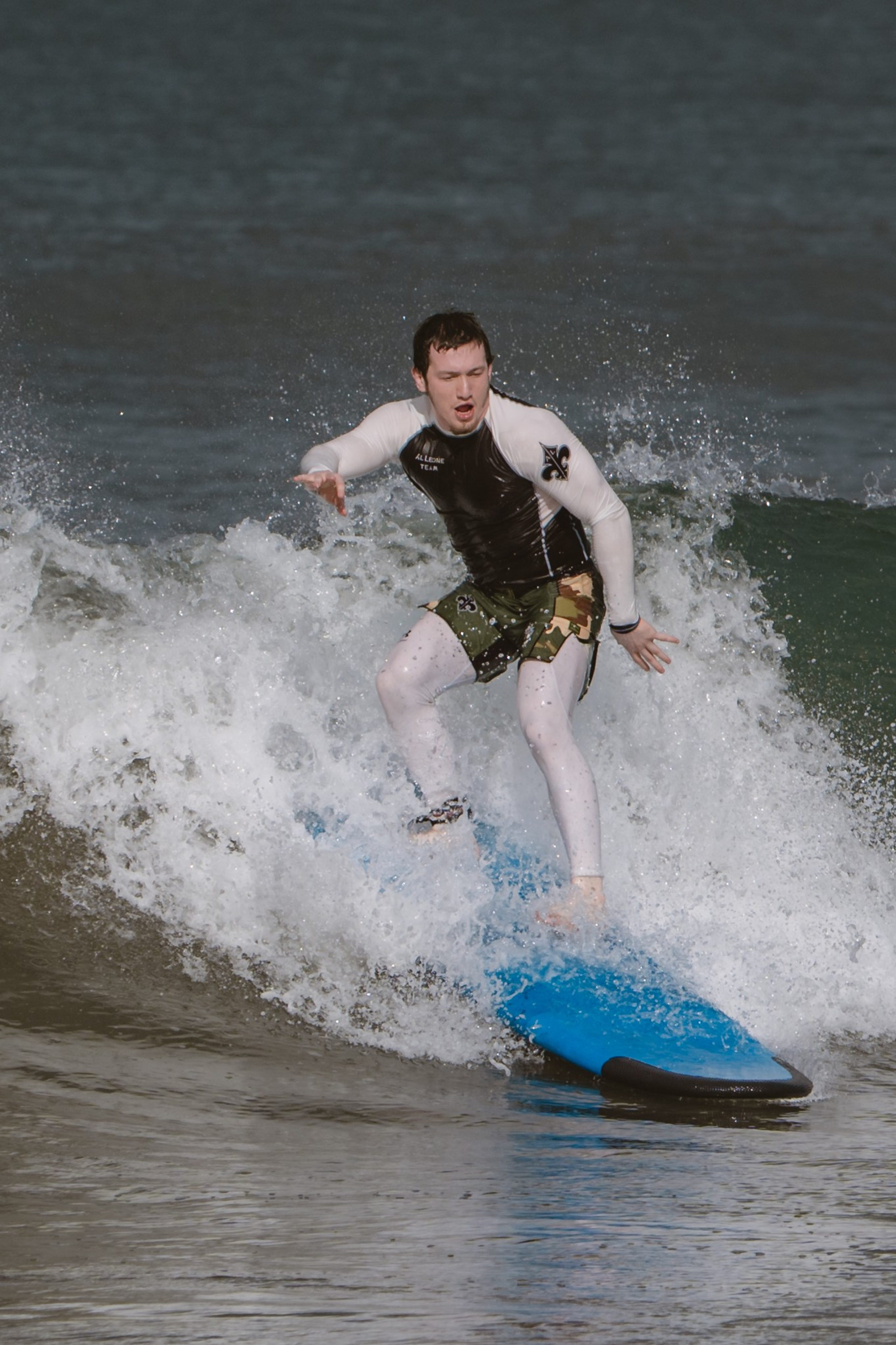 Mixed martial artists having fun surfing at the ocean in between training sessions. Сергей Зворыгин
