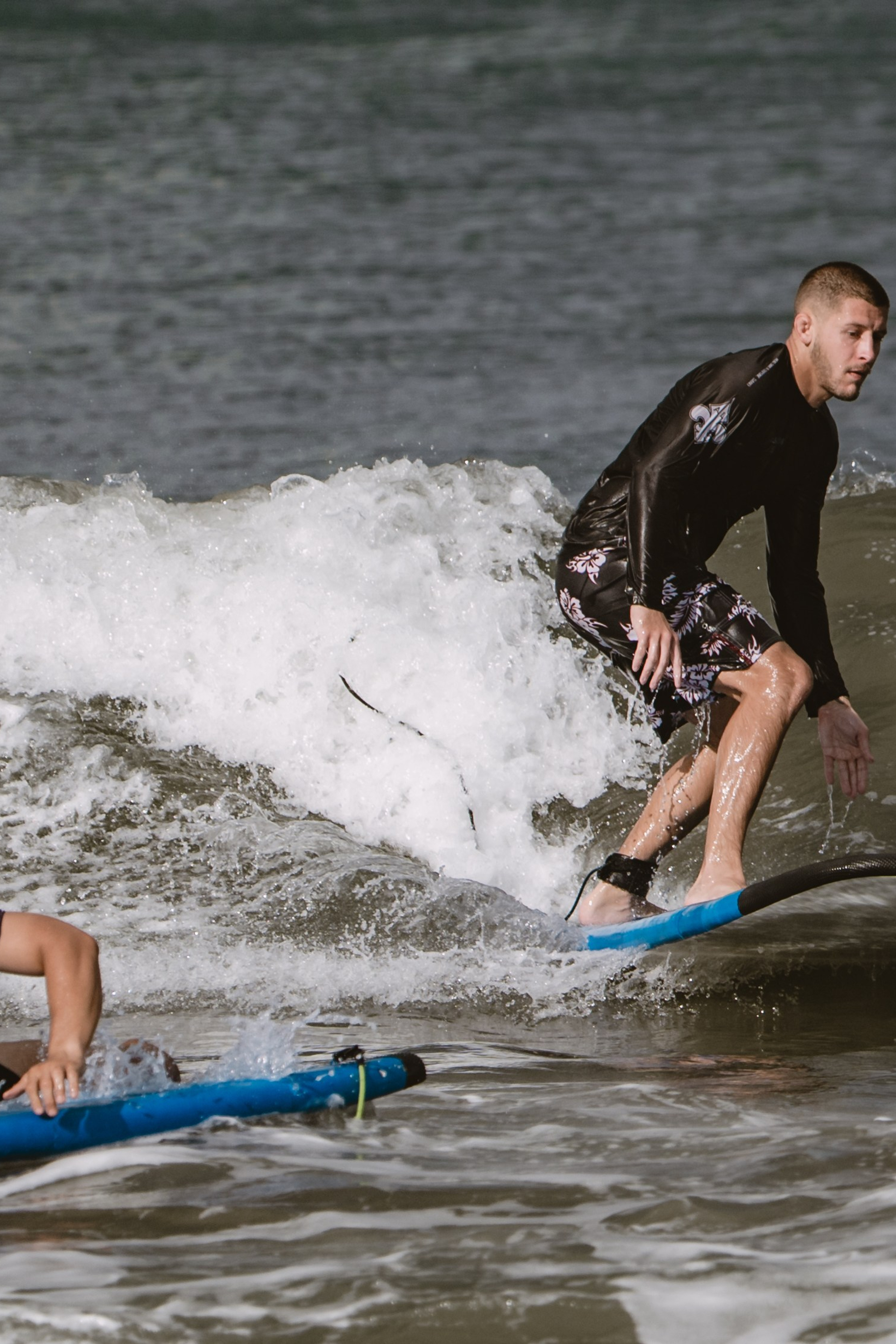 Mixed martial artists having fun surfing at the ocean in between training sessions. Сергей Зворыгин
