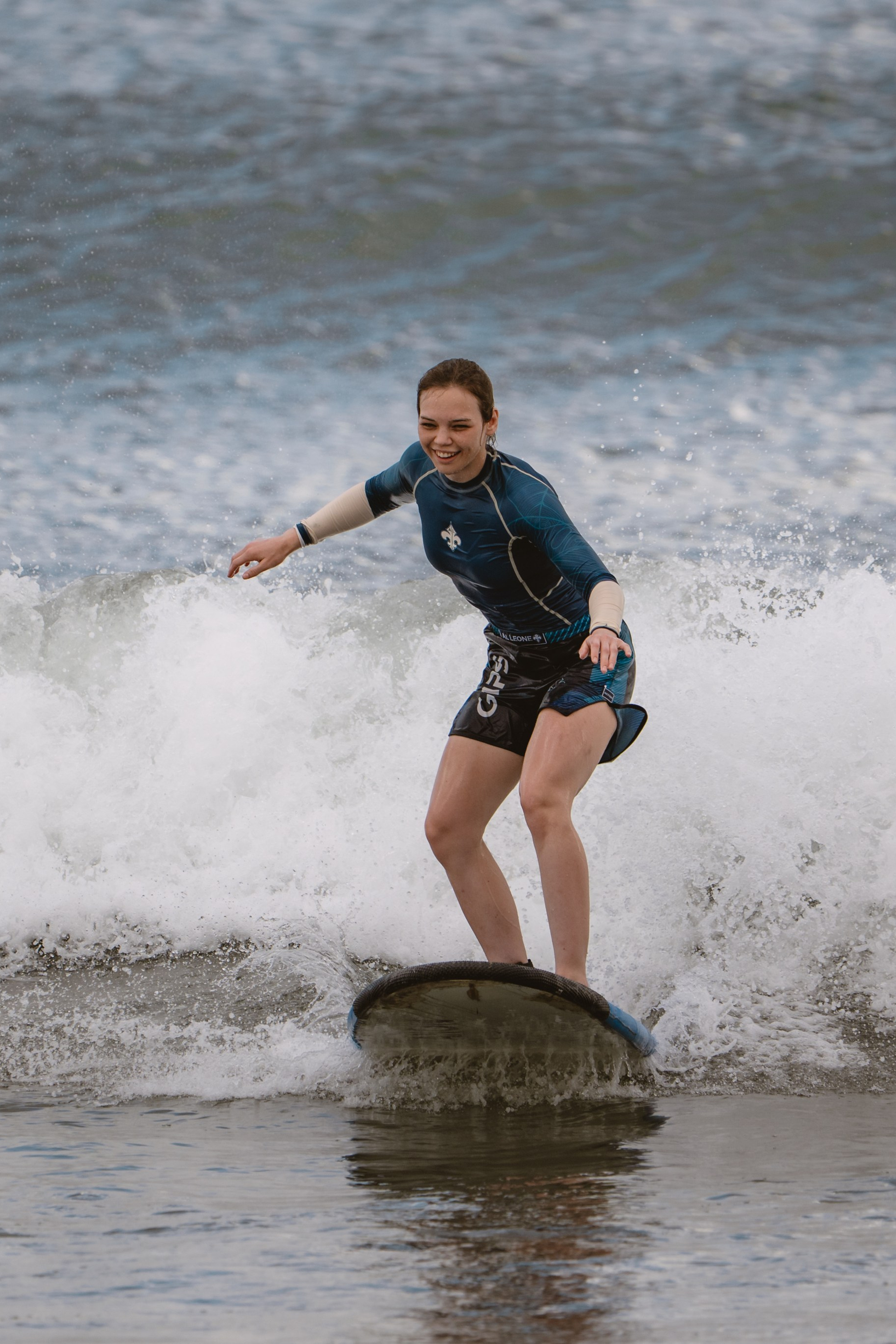 Mixed martial artists having fun surfing at the ocean in between training sessions. Сергей Зворыгин