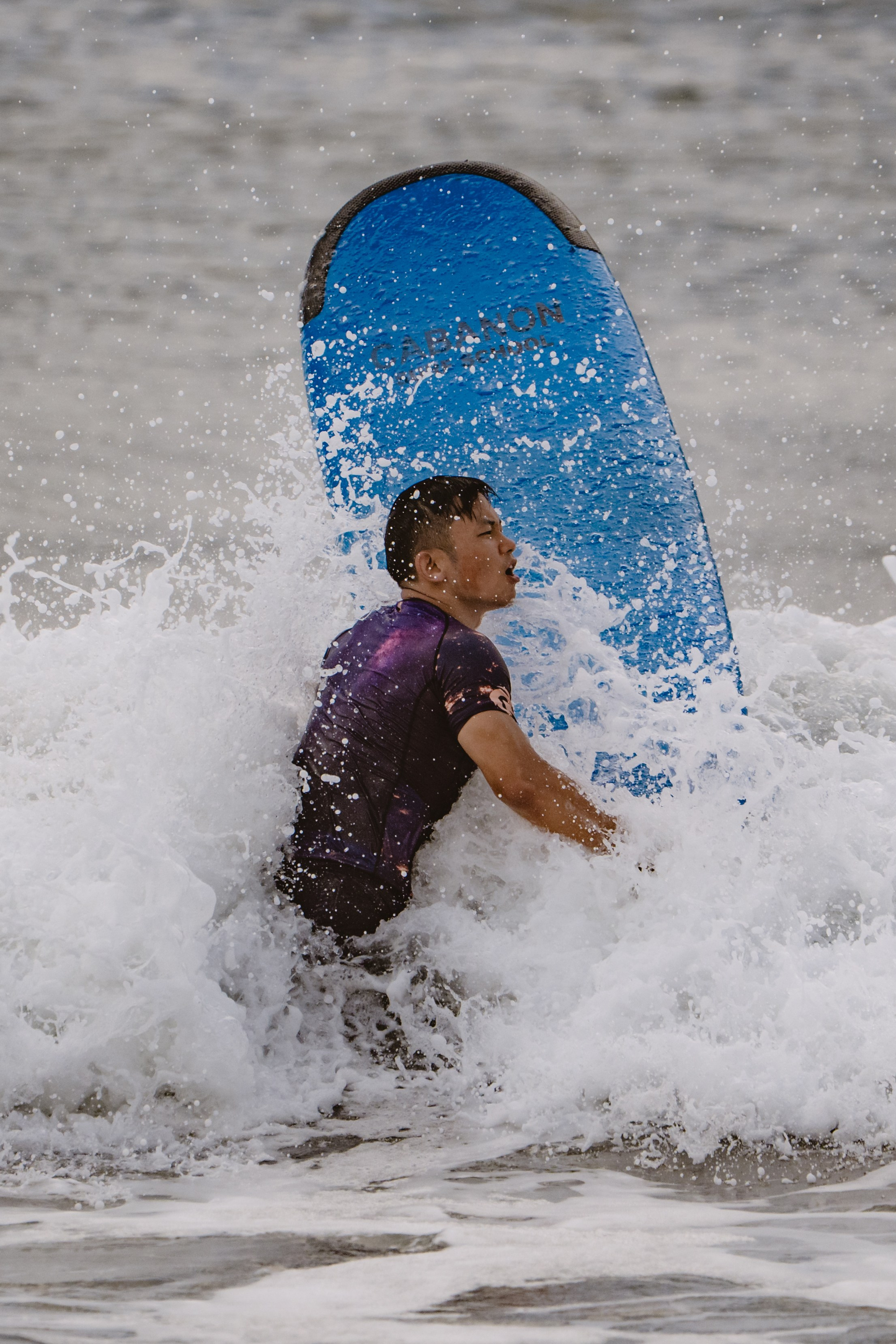 Mixed martial artists having fun surfing at the ocean in between training sessions. Сергей Зворыгин