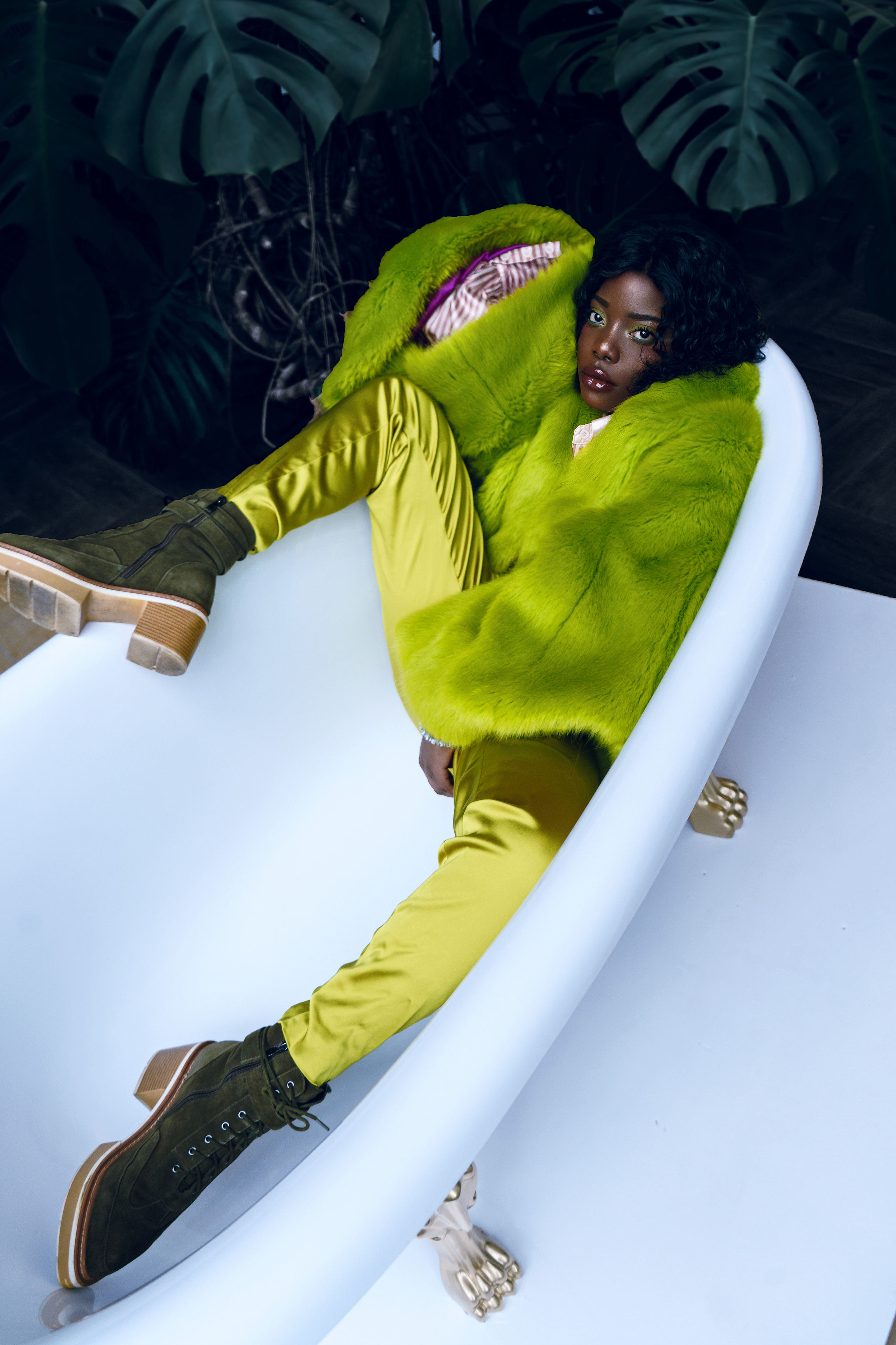 Девушка в зеленом костюме лежит в ванной