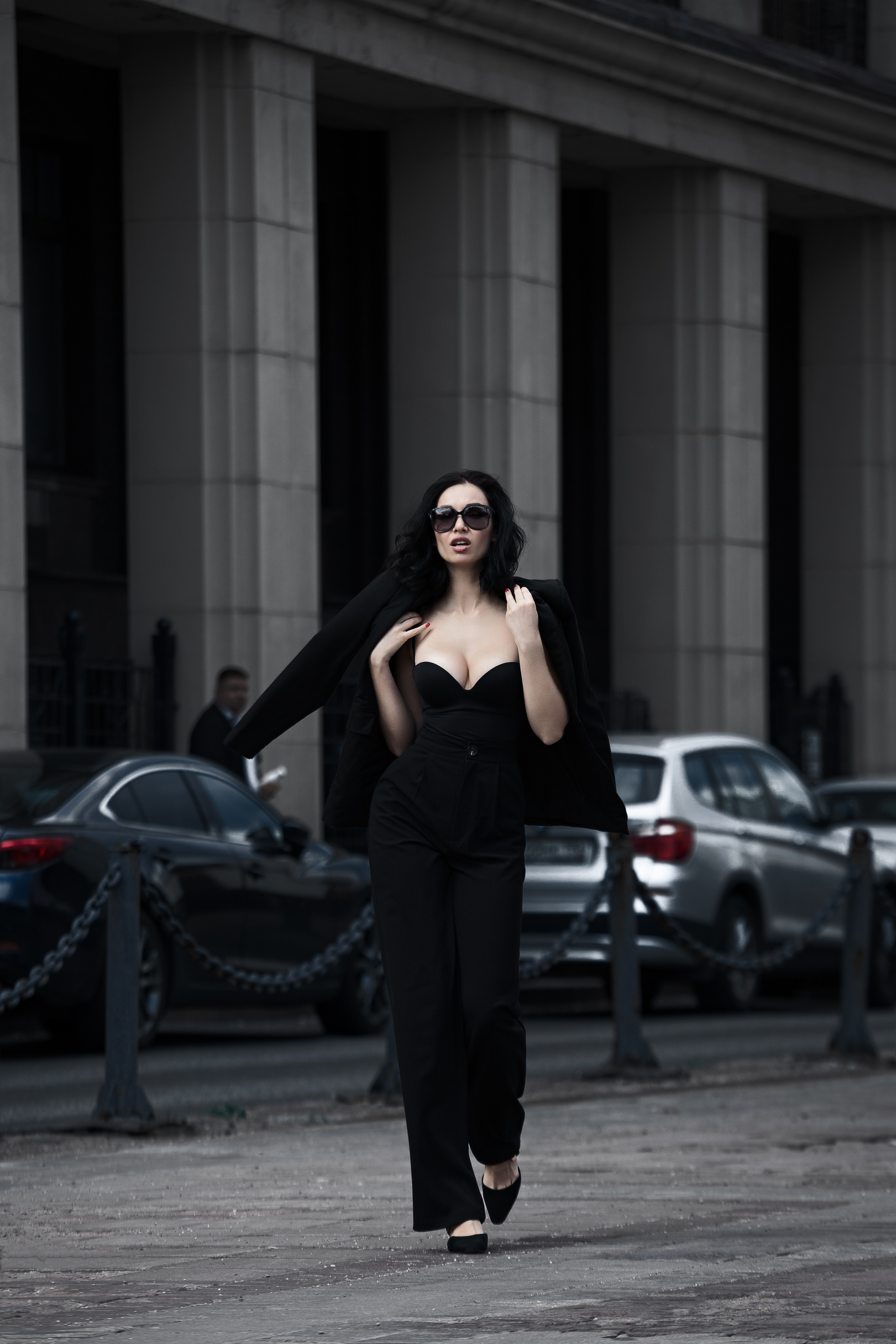 Девушка в строгом костюме прогуливается по городу