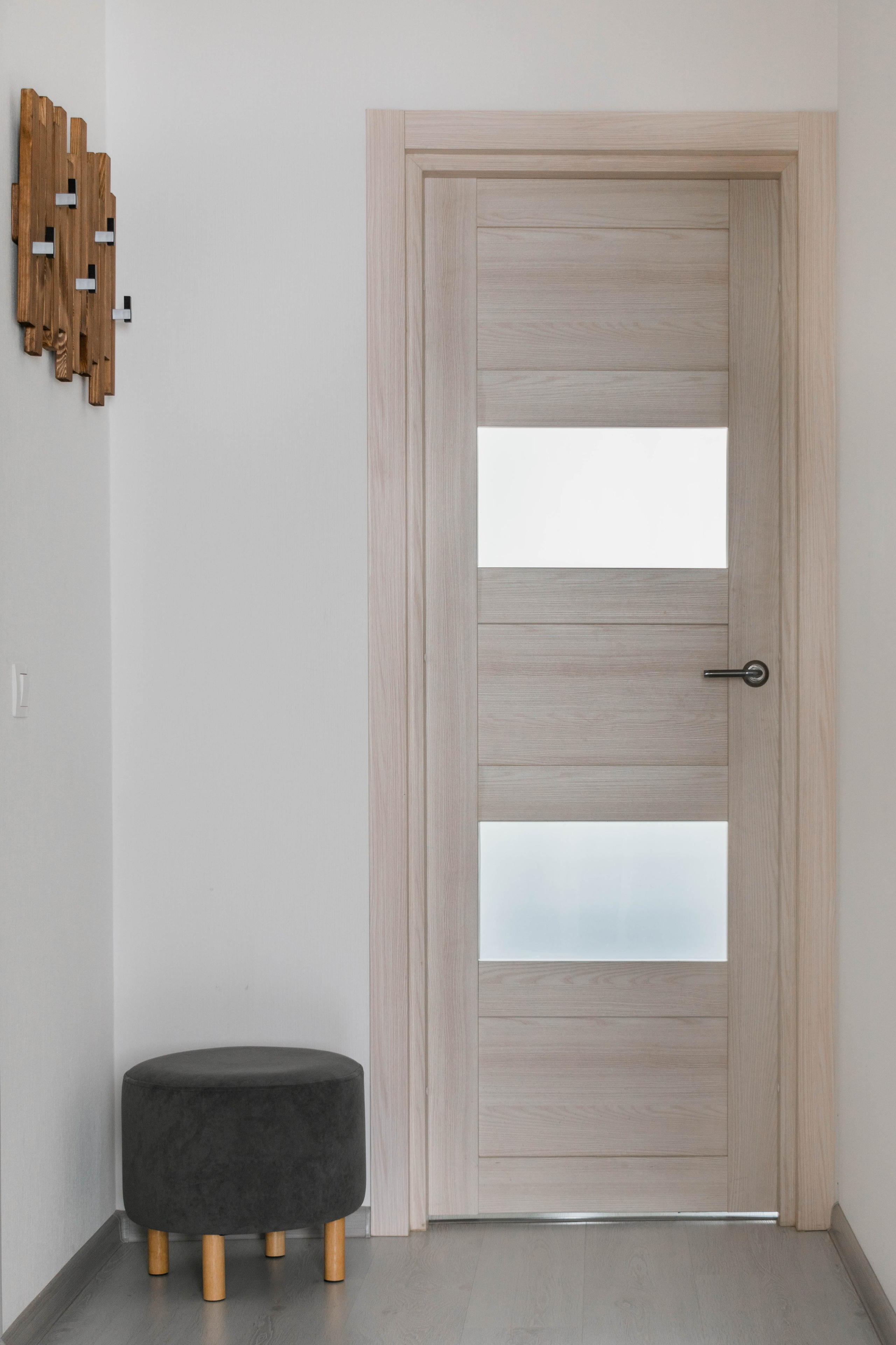 маленькая прихожая с пуфиком и вешелкой