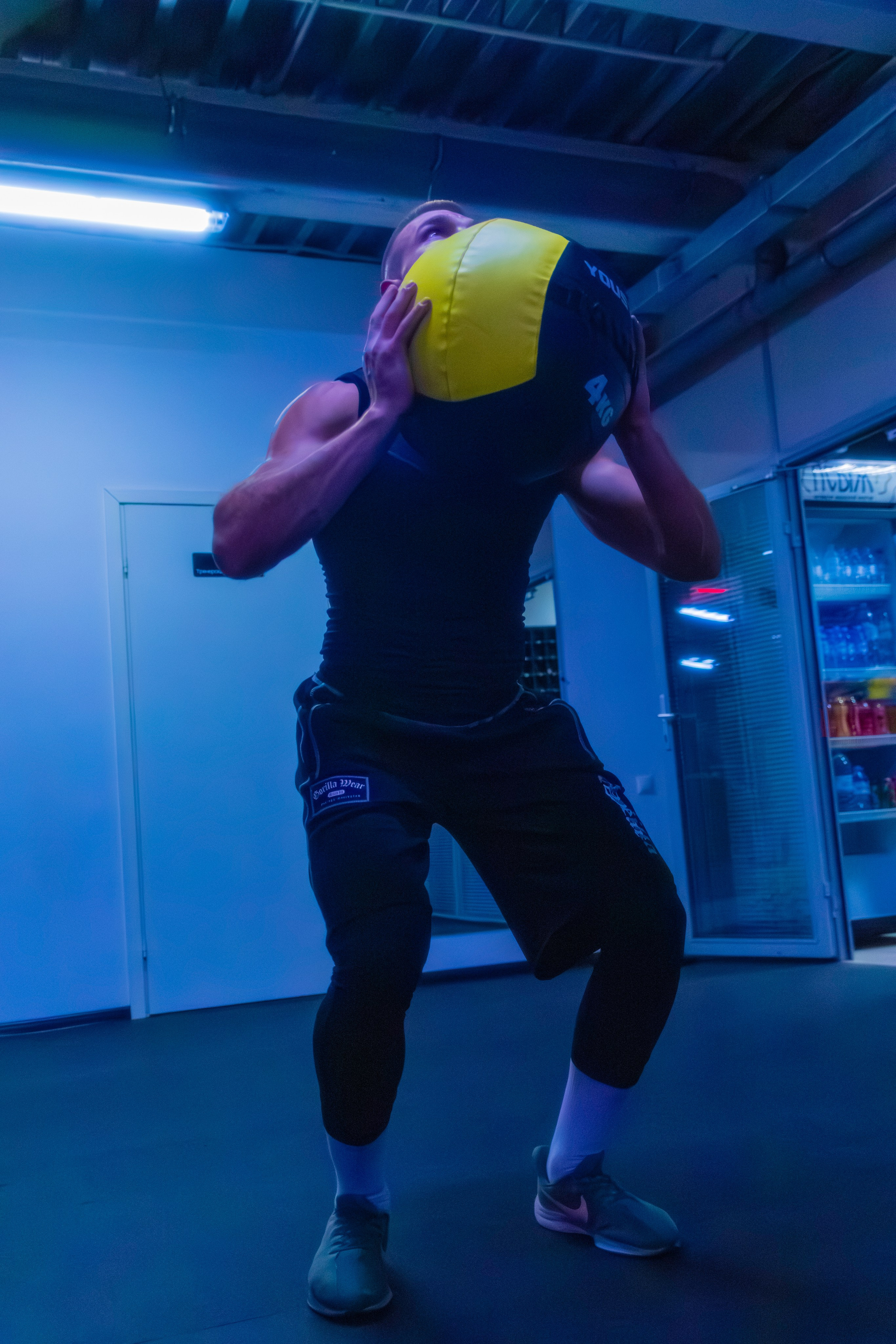 Журнальный портрет мускулистого наставника, где свет подчеркивает красоту тела.