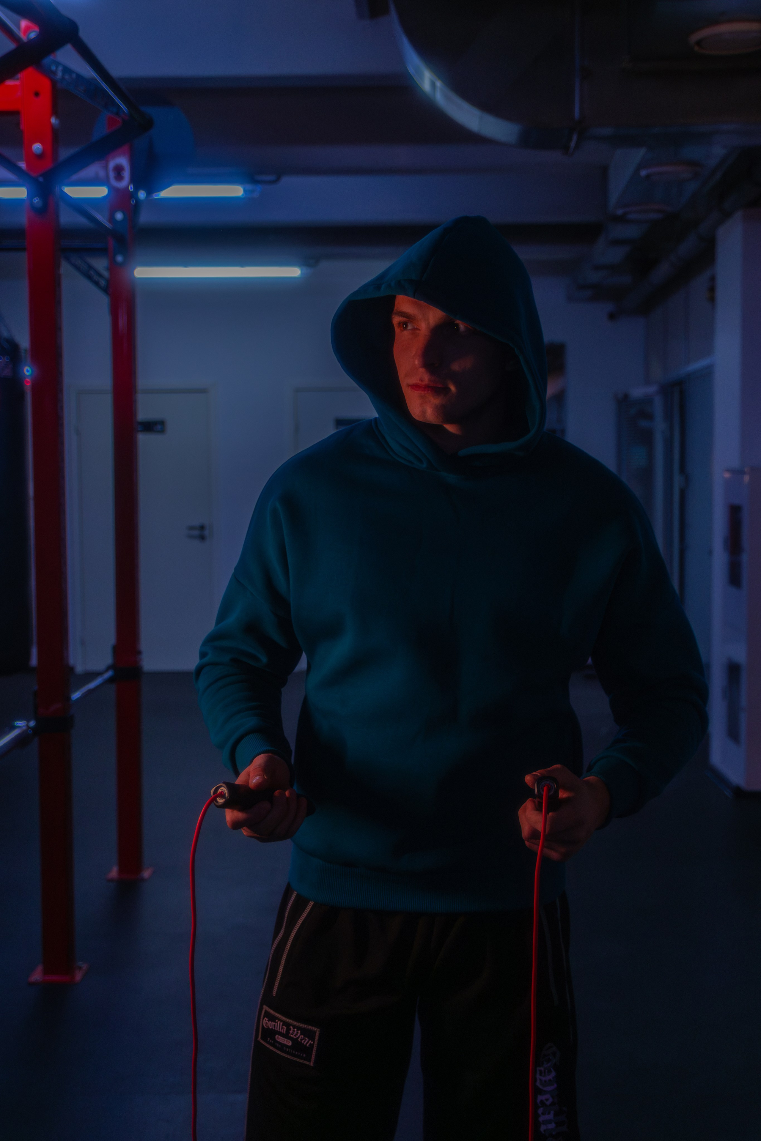 Роскошная фотография тренера в неоновом свете, передающая силу и уверенность спортивного профессионала.