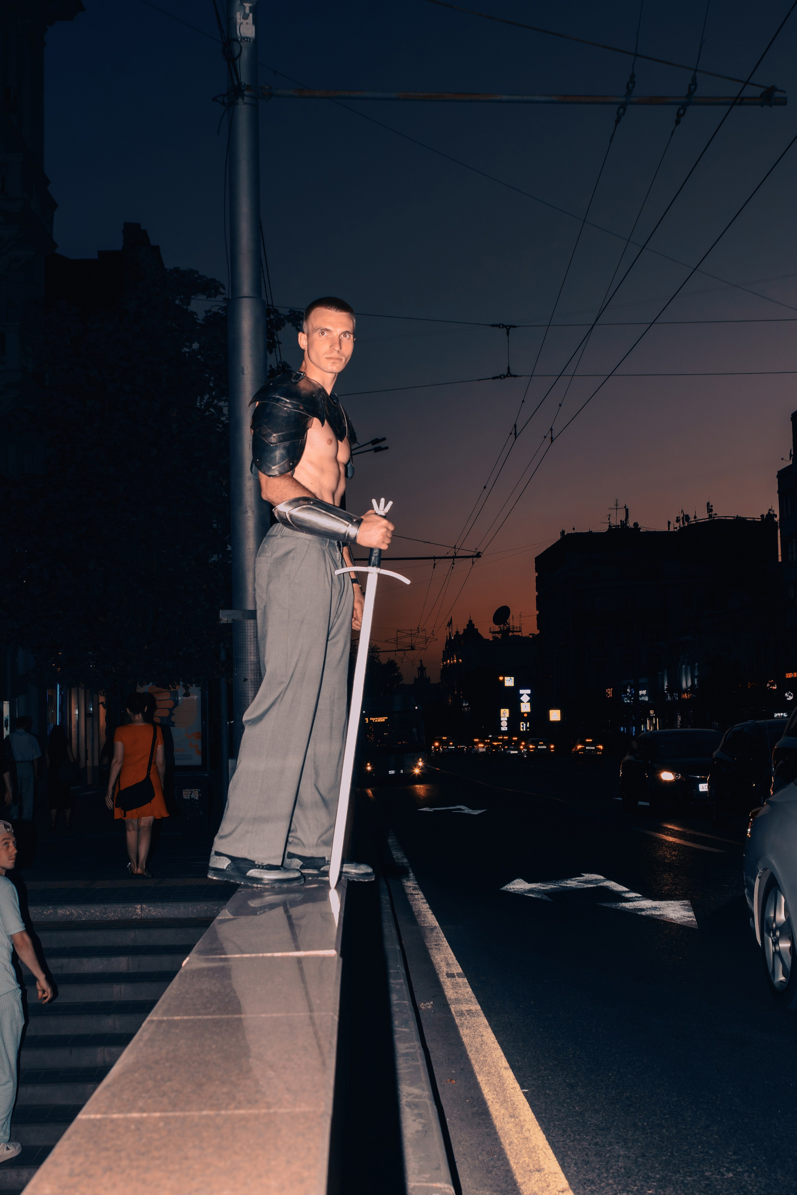 Мужчина в рыцарских доспехах стоит в Центре Ростова-на-Дону на фоне заката