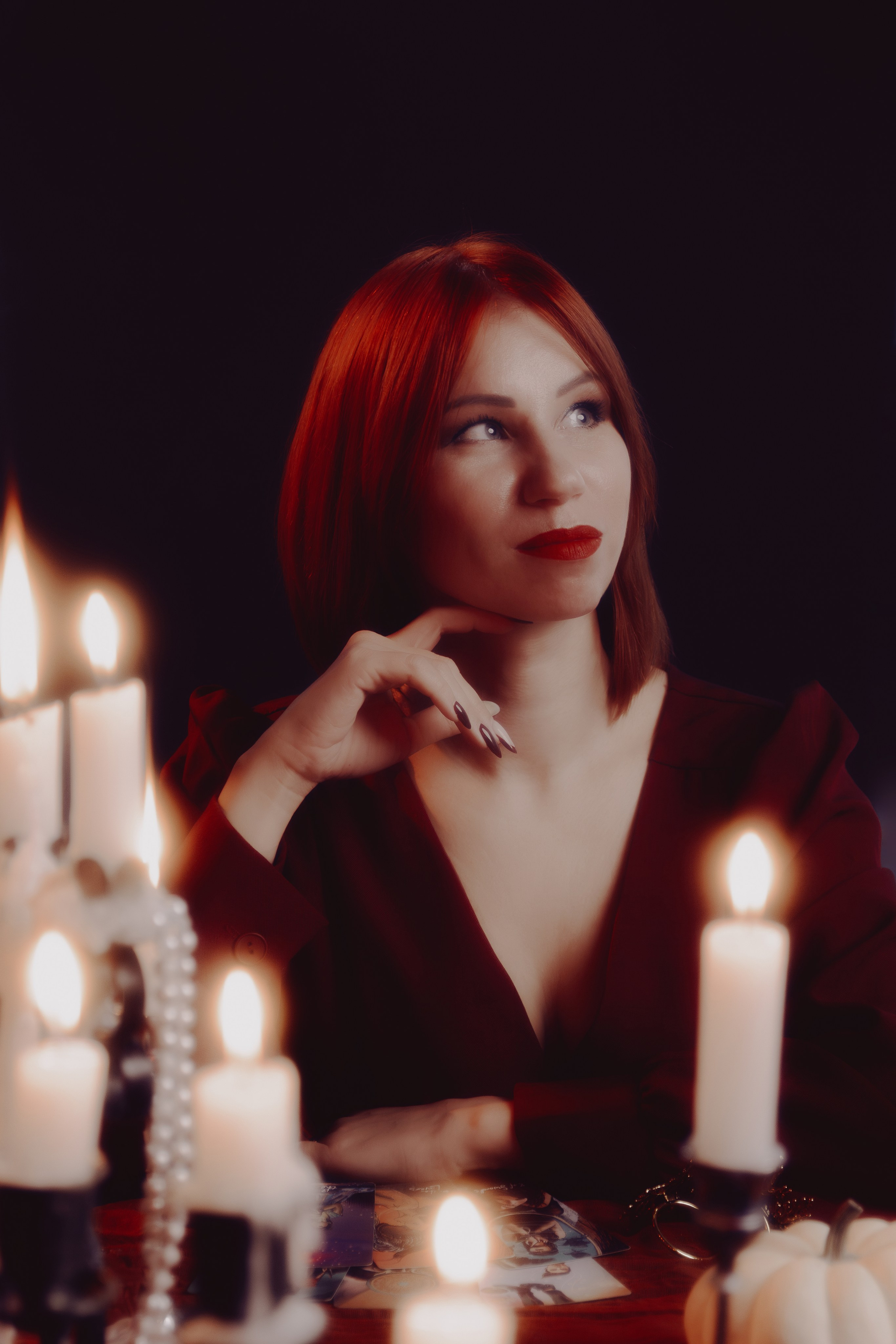 Таролог в атмосферной студии Ростова‑на‑Дону. Нежный боковой свет выделяет тонкие черты лица и изящные руки.