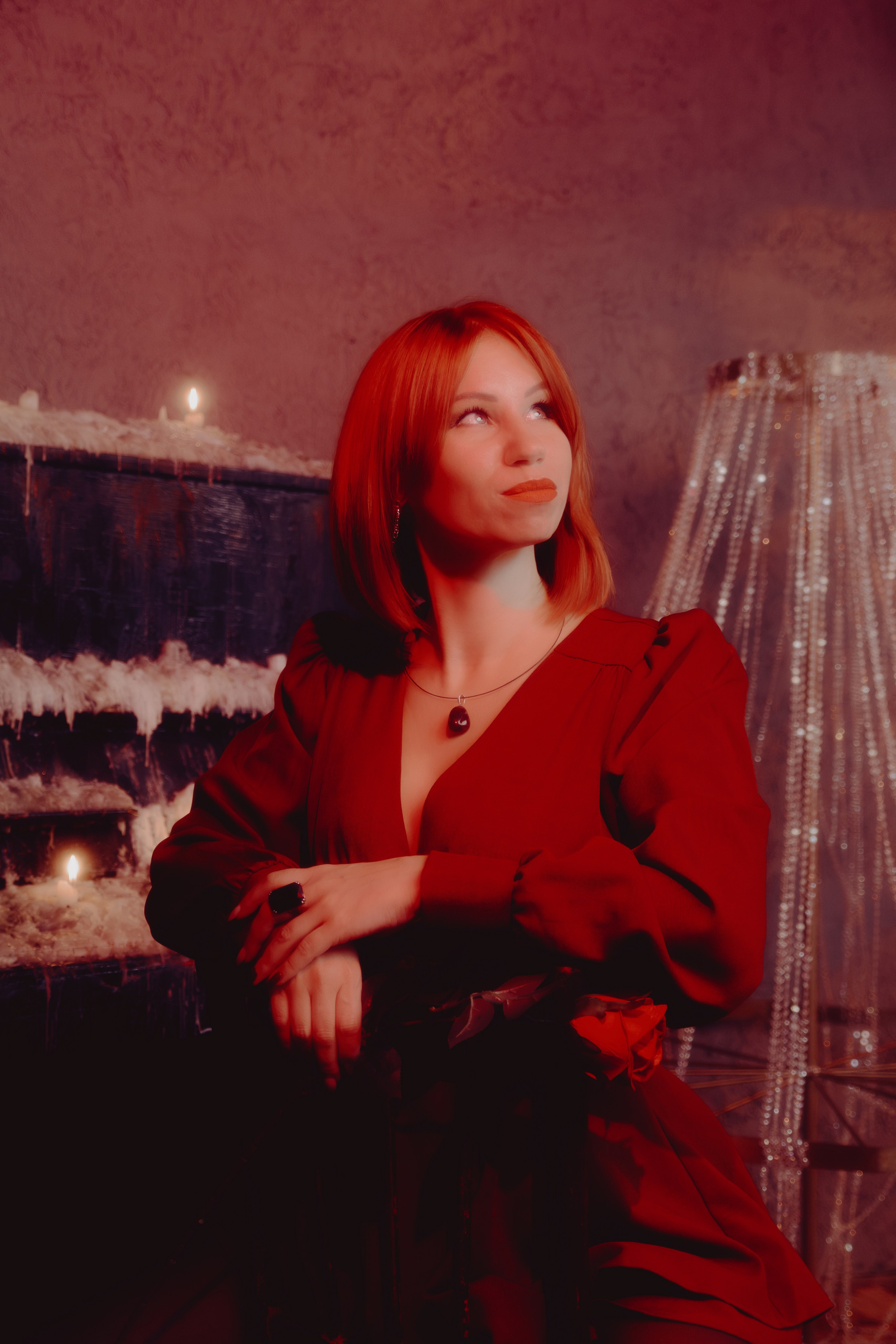 Таролог с лёгкой улыбкой, взгляд в камеру. Тёплый тон кожи гармонирует с нейтральным фоном.