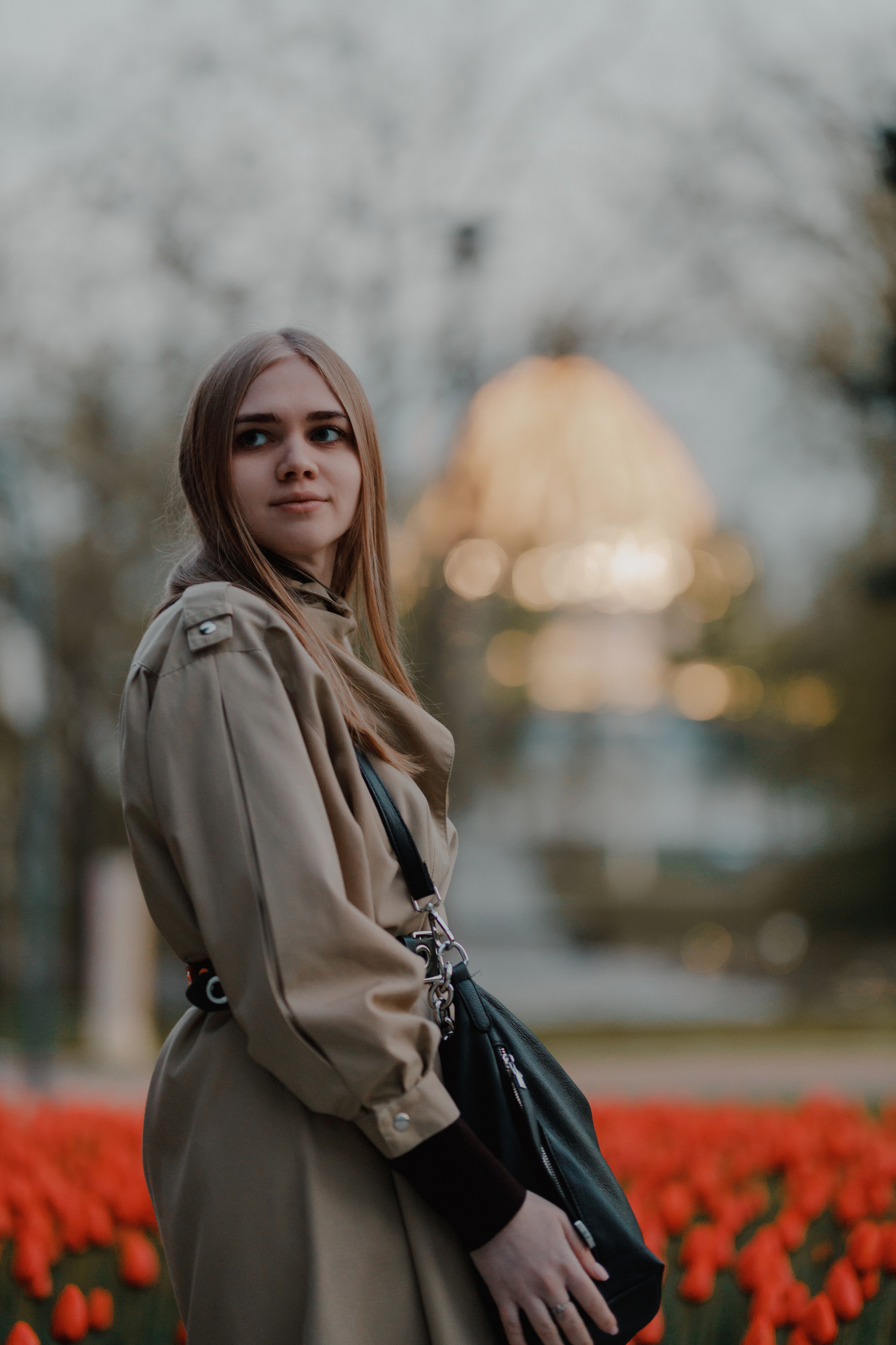 Портретная фотосессия в цветущем поле тюльпанов, профессиональная съёмка девушки в бежевом пальто