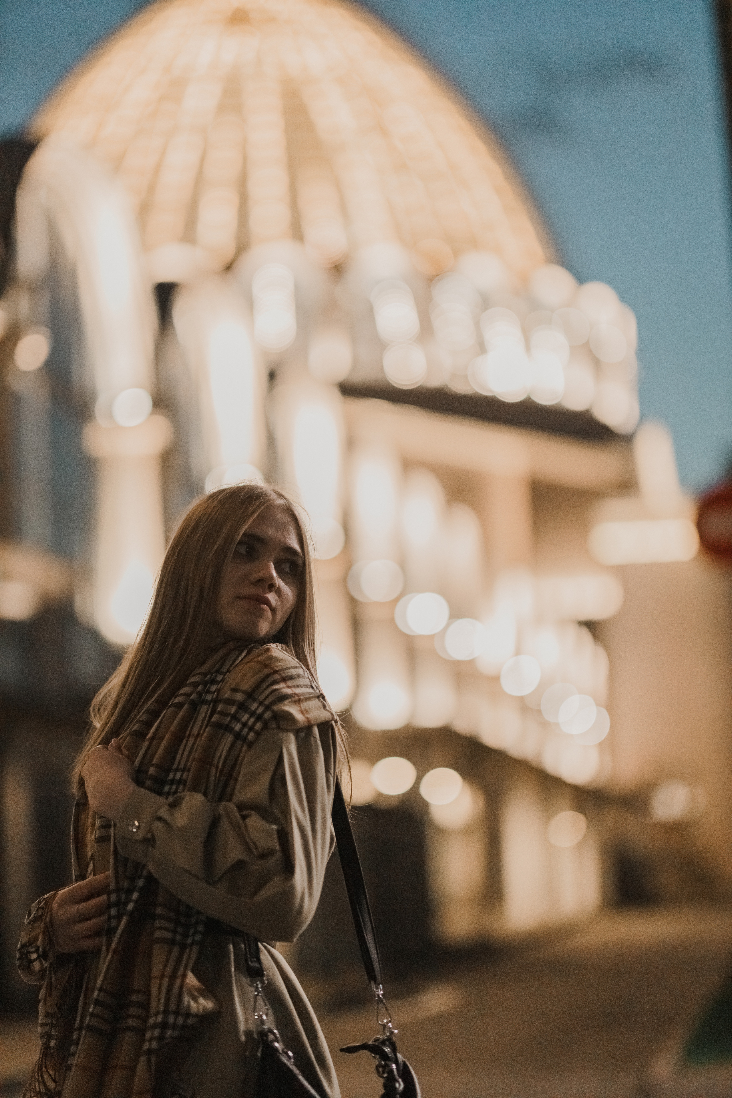 Женский портрет с видом на белую архитектуру, яркий дневной свет, классический стиль съёмки