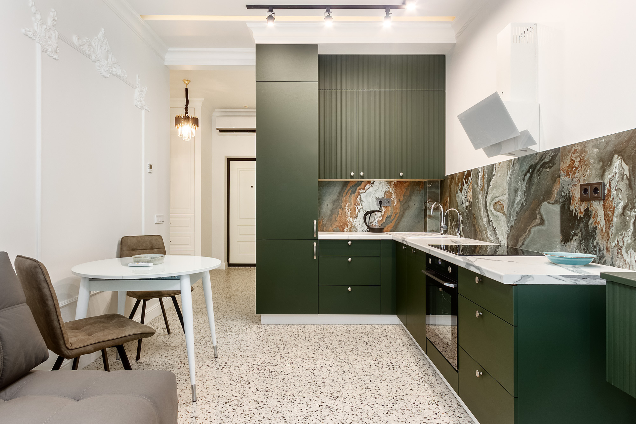 Интерьерная фотосъёмка тёмно-зелёной кухни с белыми стенами