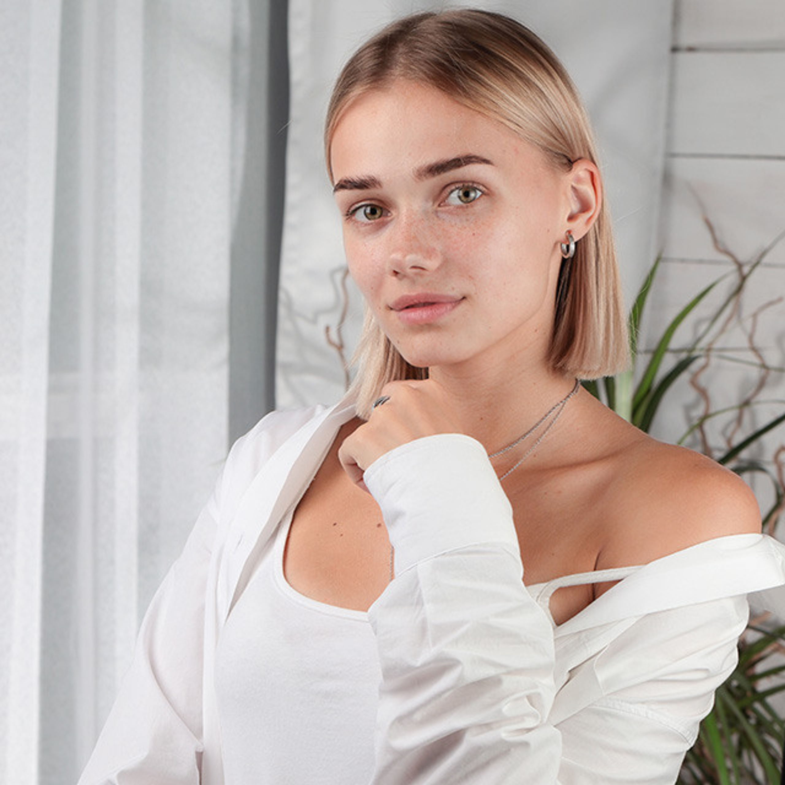 Студийный портрет милой девушки в светлой одежде