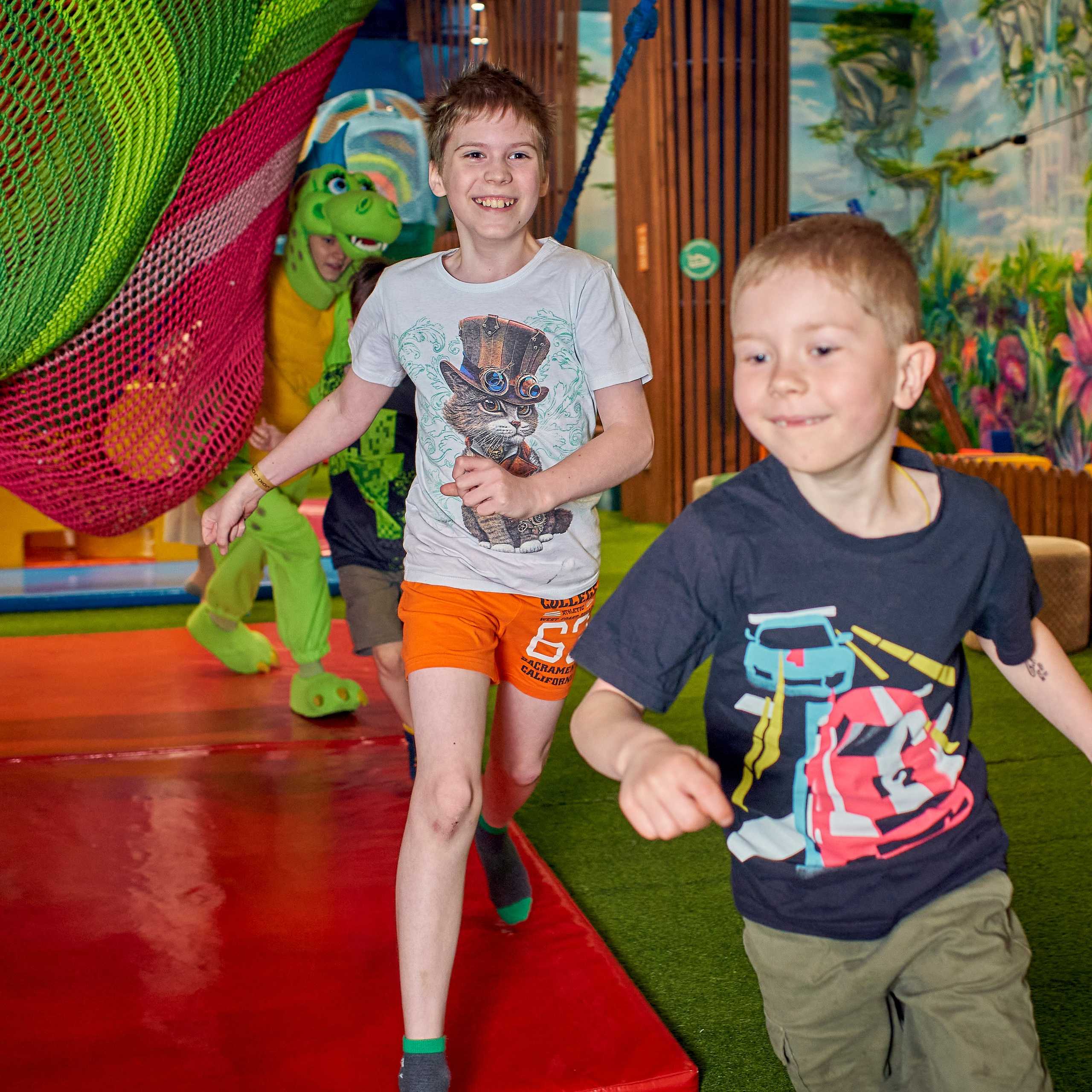 Дети веселые убегают от аниматора в костюме