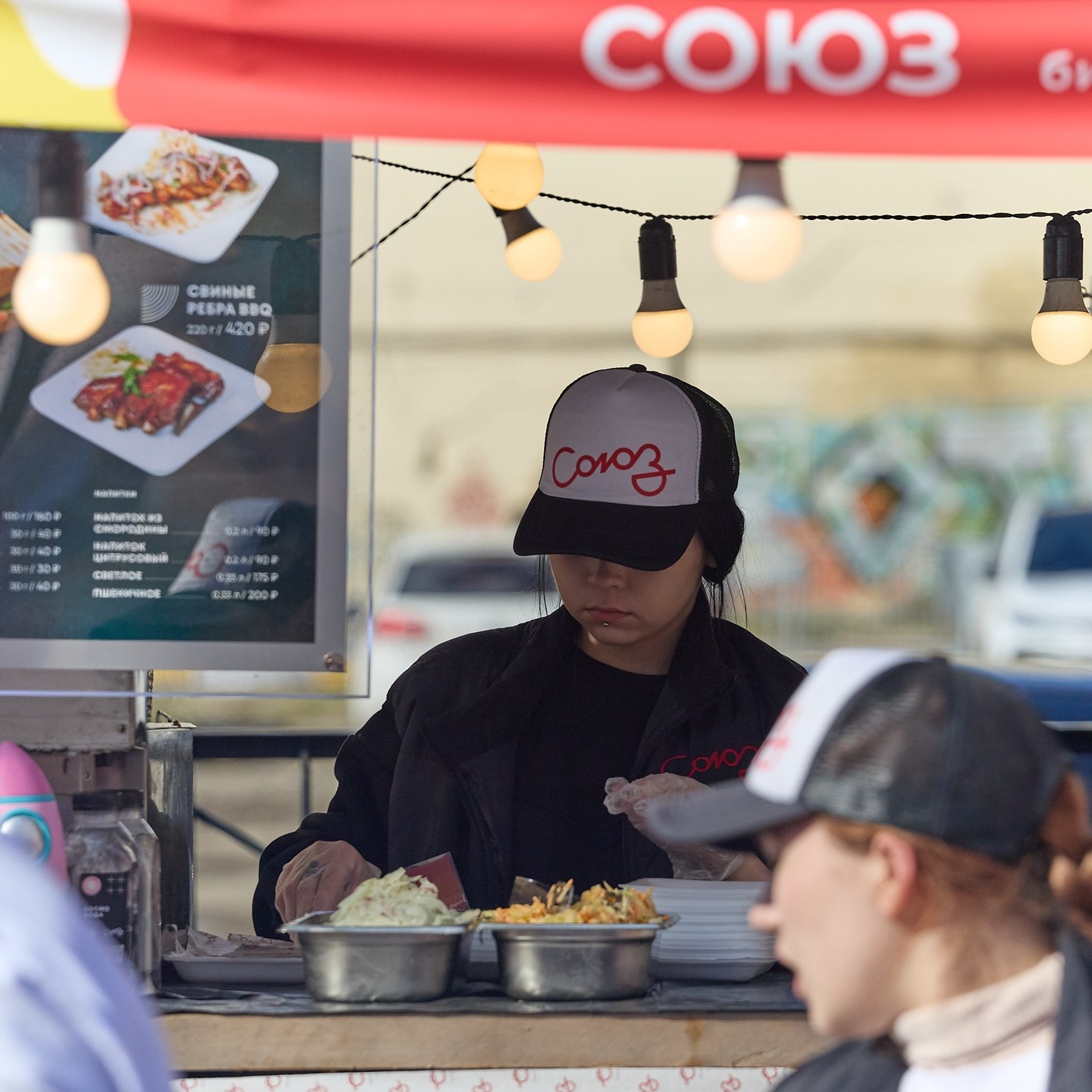 Бармен принимает заказ на фудфестивале.