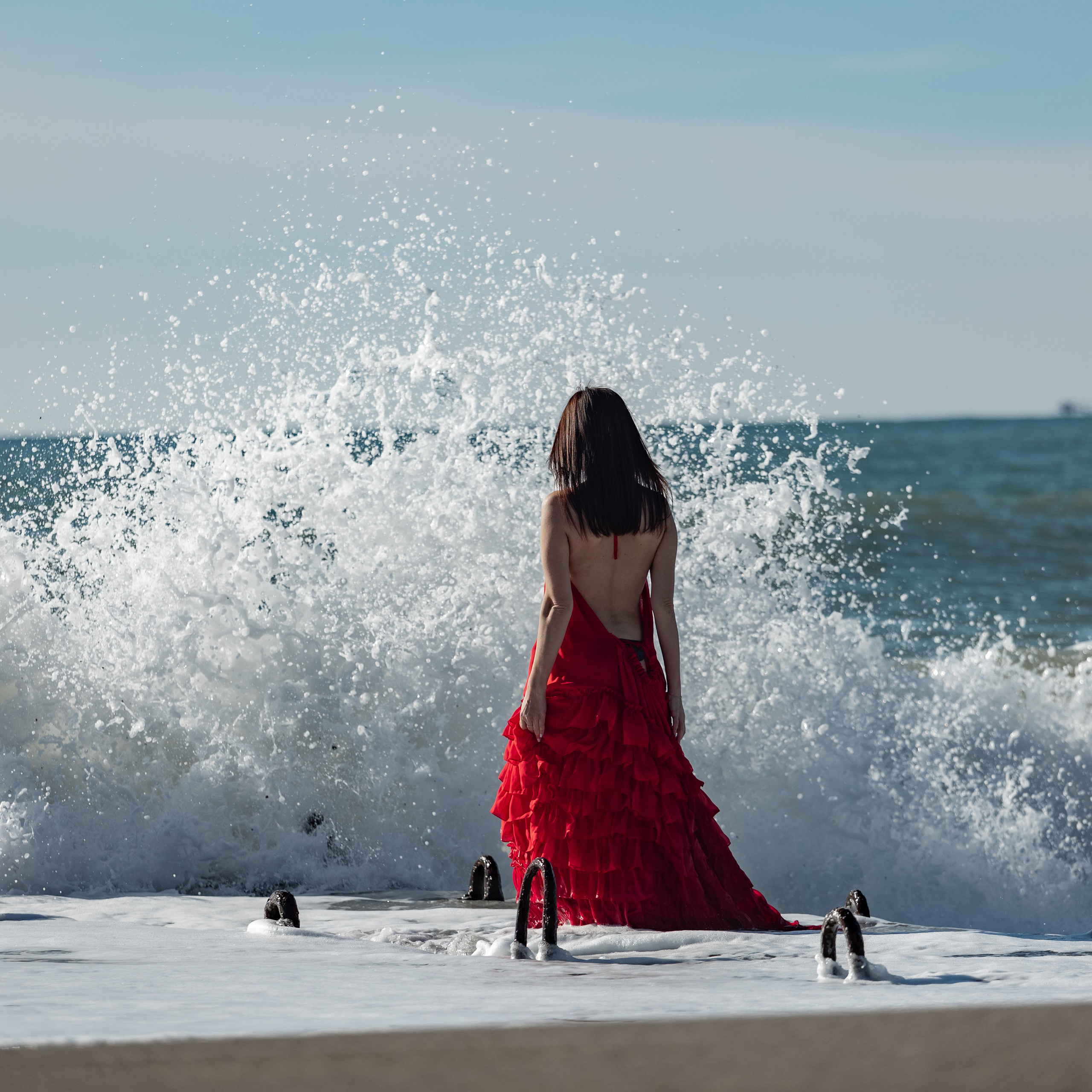 shooting in a red dress in the sea