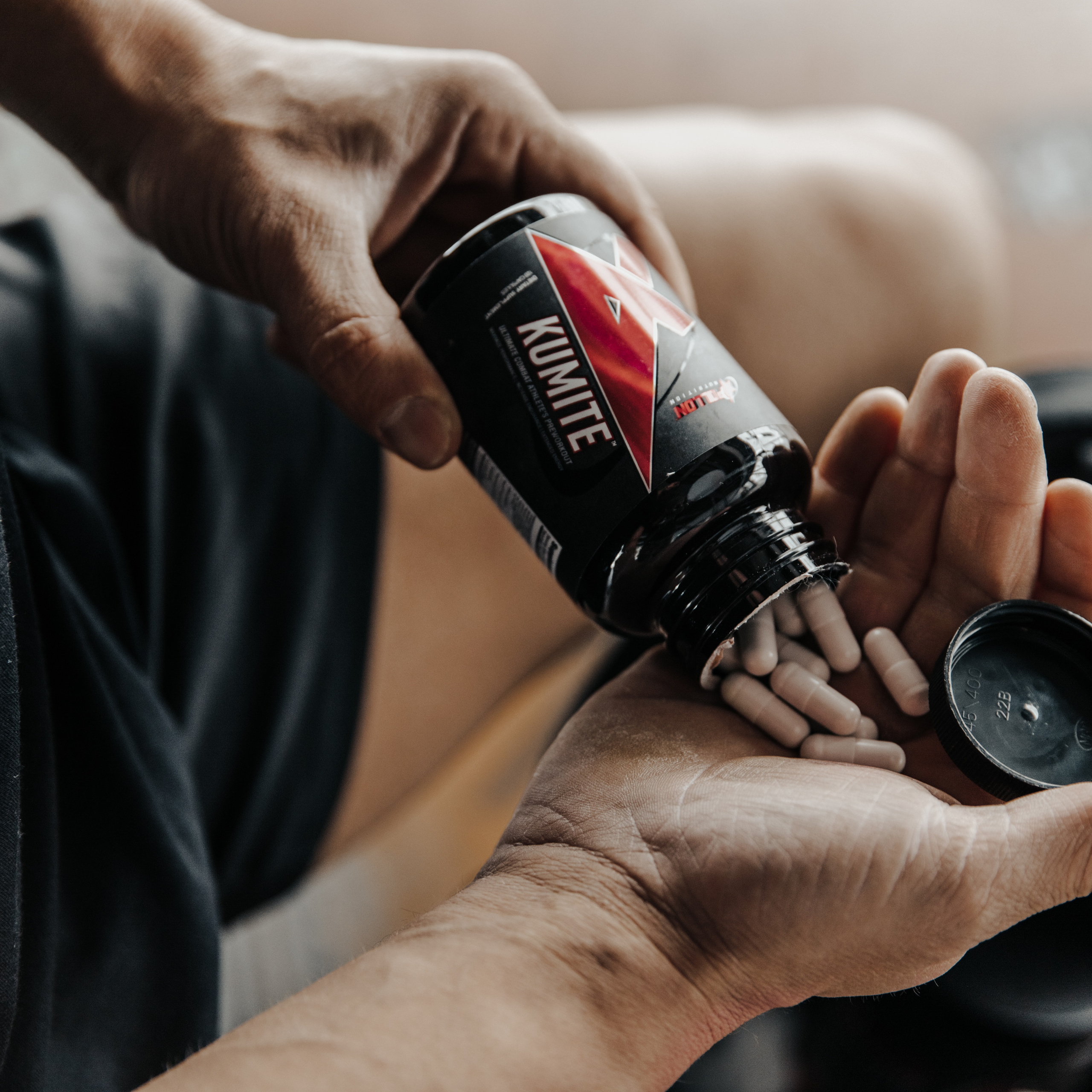 банка с витаминами в руках у мужчины перед тренировкой